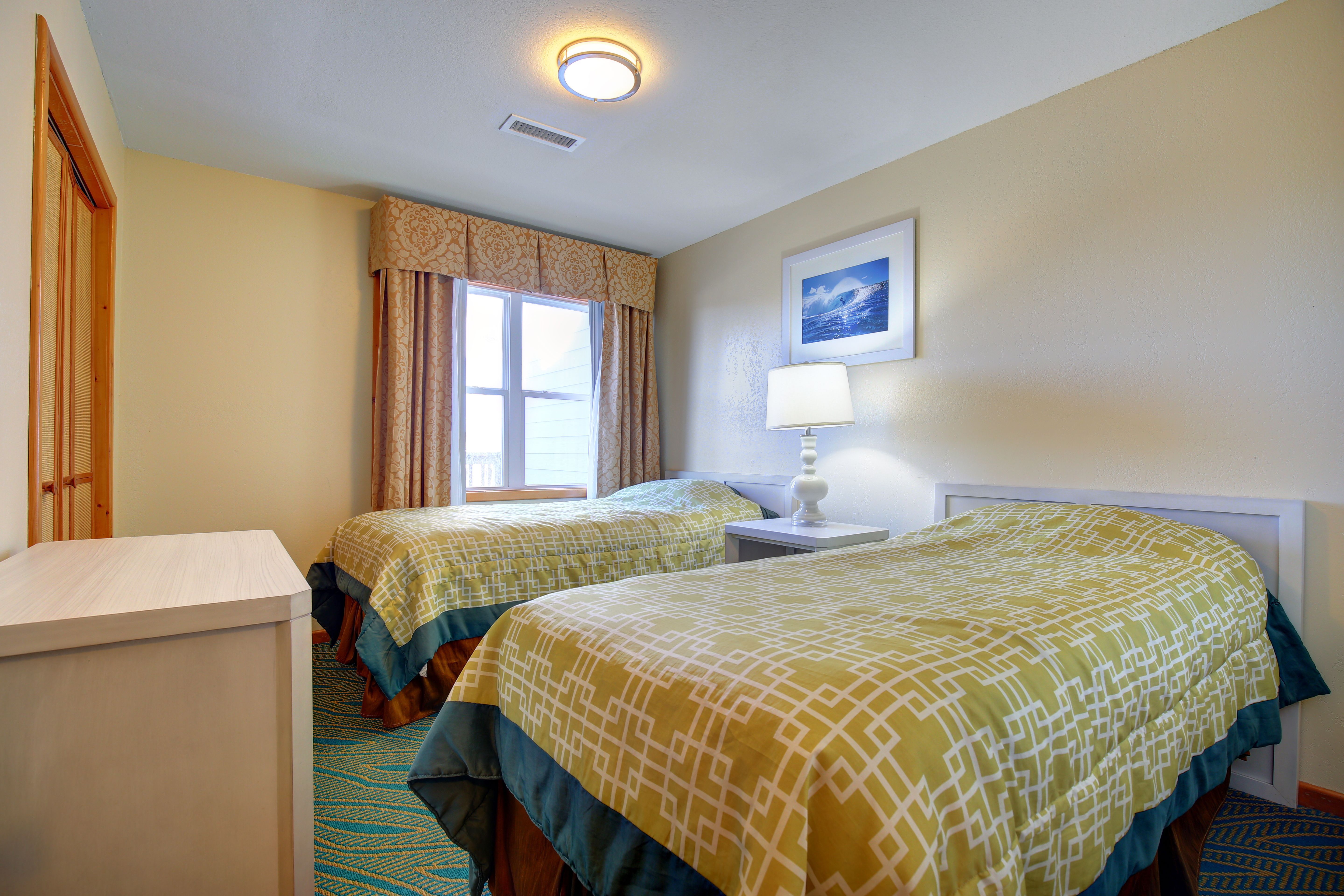 image Bright and cheerful, the second bedroom features twin beds and plenty of natural light, perfect for family or guests.