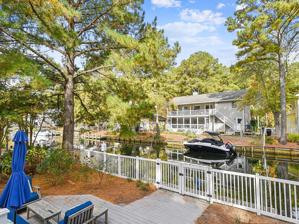 image This charming waterfront home boasts relaxing coastal decor, surrounded by serene trees and a private dock, perfect for unwinding by the water.