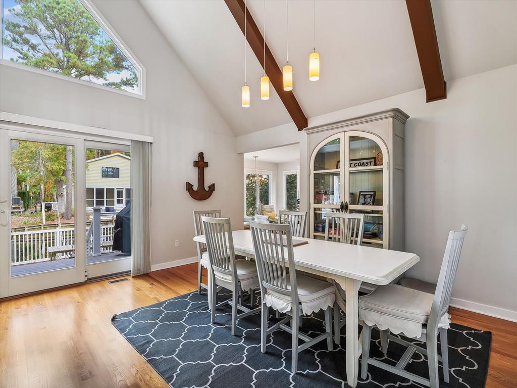 image This charming dining area boasts natural light and elegant decor, perfect for family gatherings with stunning outdoor views.