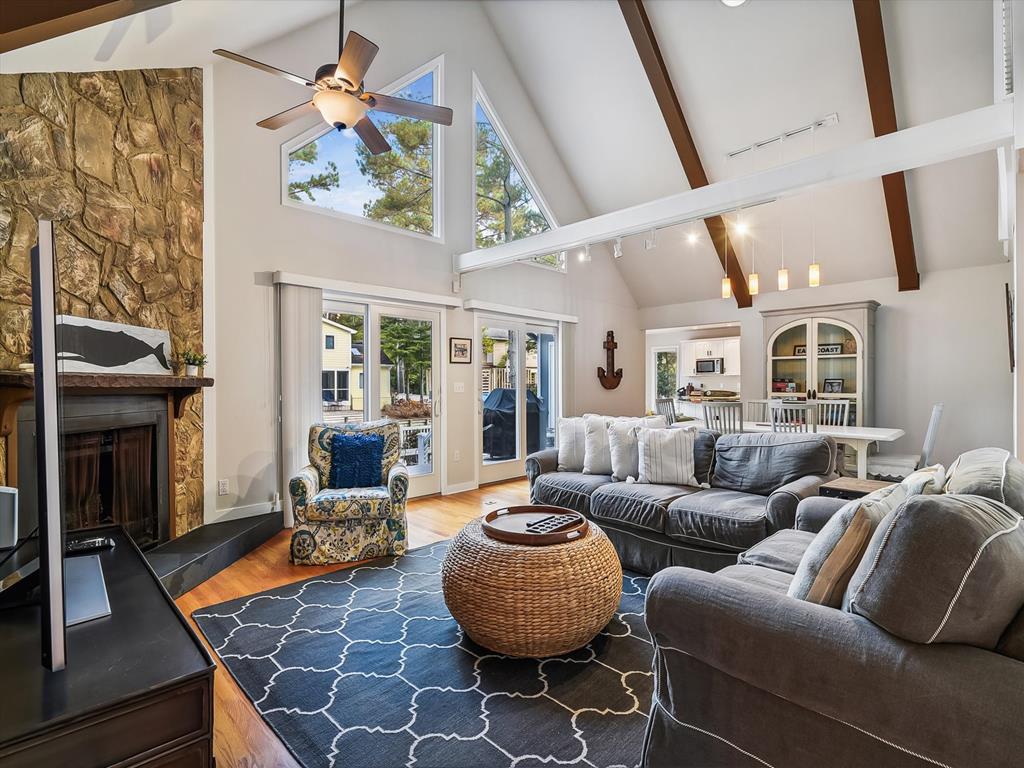 image Contemporary living space that blends comfort and modern design, highlighting large glass doors that open to the serene coastal outdoors.