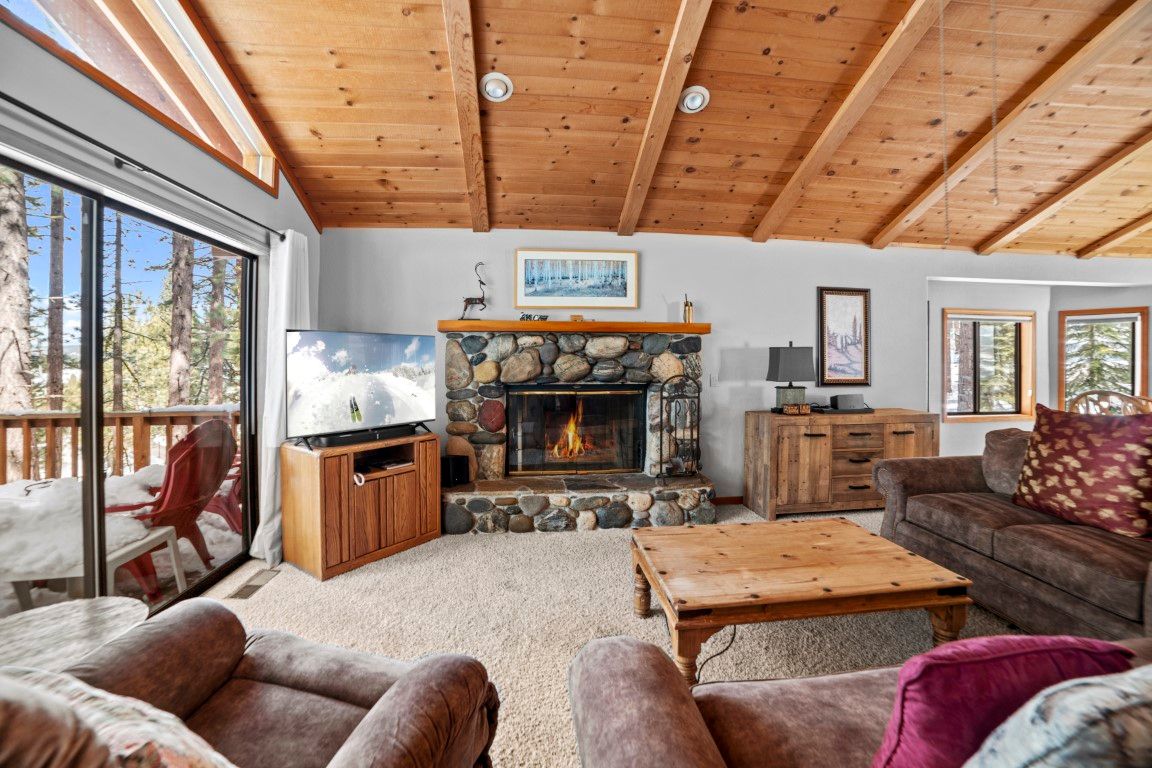 image The cozy living room features a stunning stone fireplace, perfect for warming up after a day outdoors.