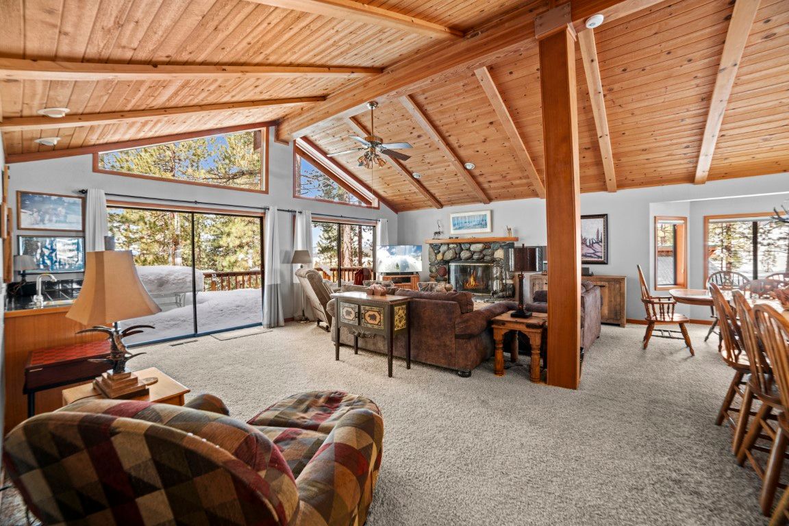 image An open-concept layout highlights the living area and dining space, boasting scenic views of the outdoors and a warm, welcoming atmosphere.