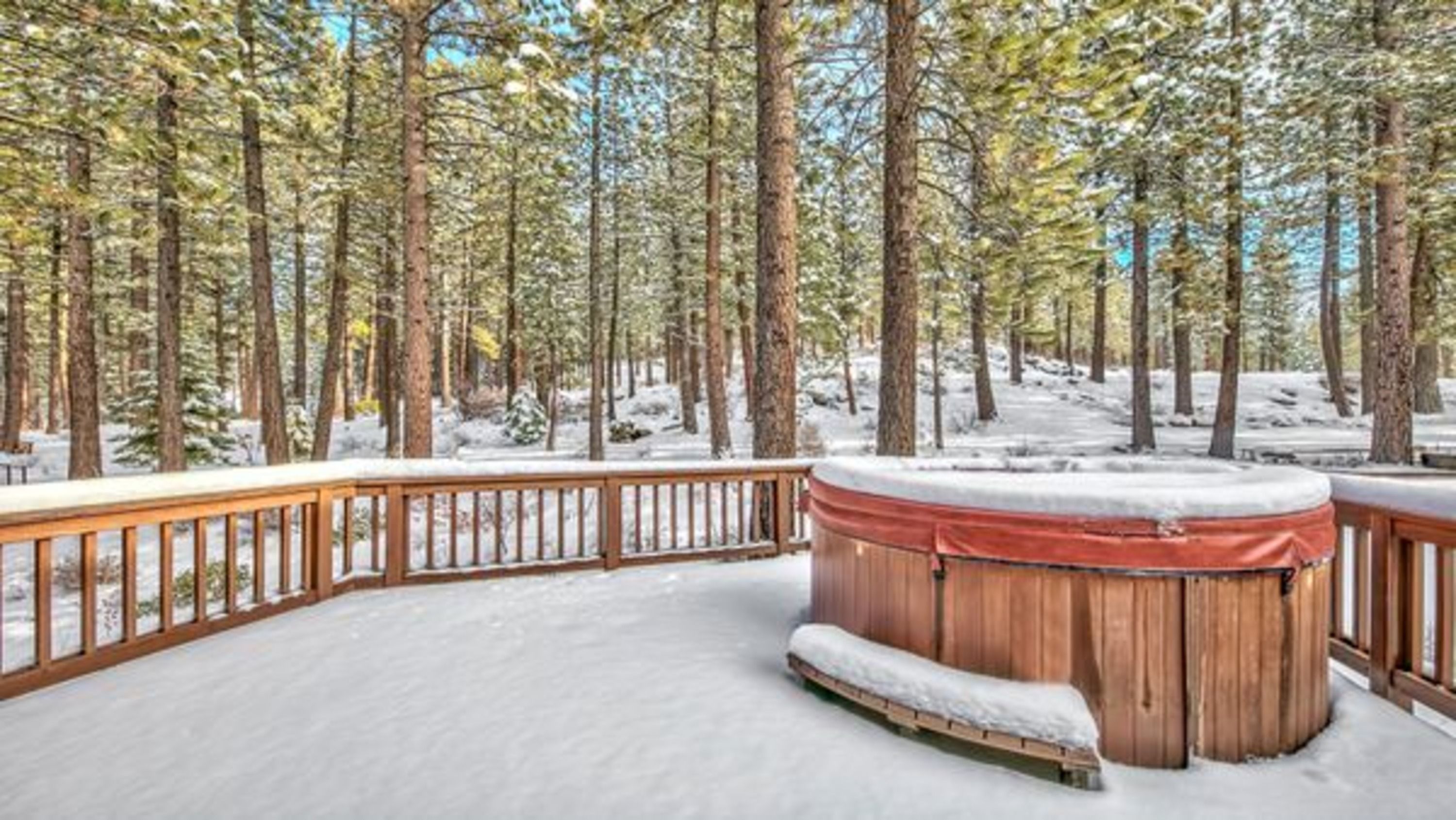 image Relax in the outdoor hot tub, where you can unwind while surrounded by the peaceful sounds of nature and stunning snowy vistas.