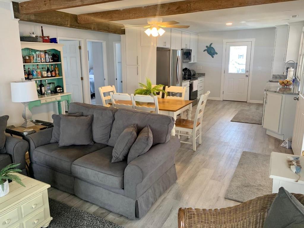 image The open layout seamlessly connects the living and dining areas, creating a warm and welcoming space with a clear view into the kitchen.