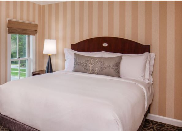 image This cozy bedroom features a plush queen-size bed in the second bedroom, adorned with elegant linens and a decorative pillow.