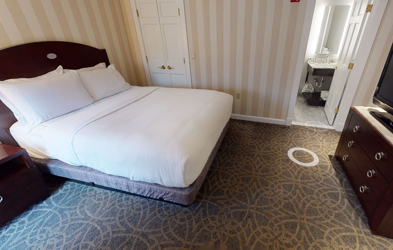 image The plush queen bedroom invites restful nights with its inviting bed, tasteful decor, and easy access to an adjoining bathroom, ensuring comfort and convenience.