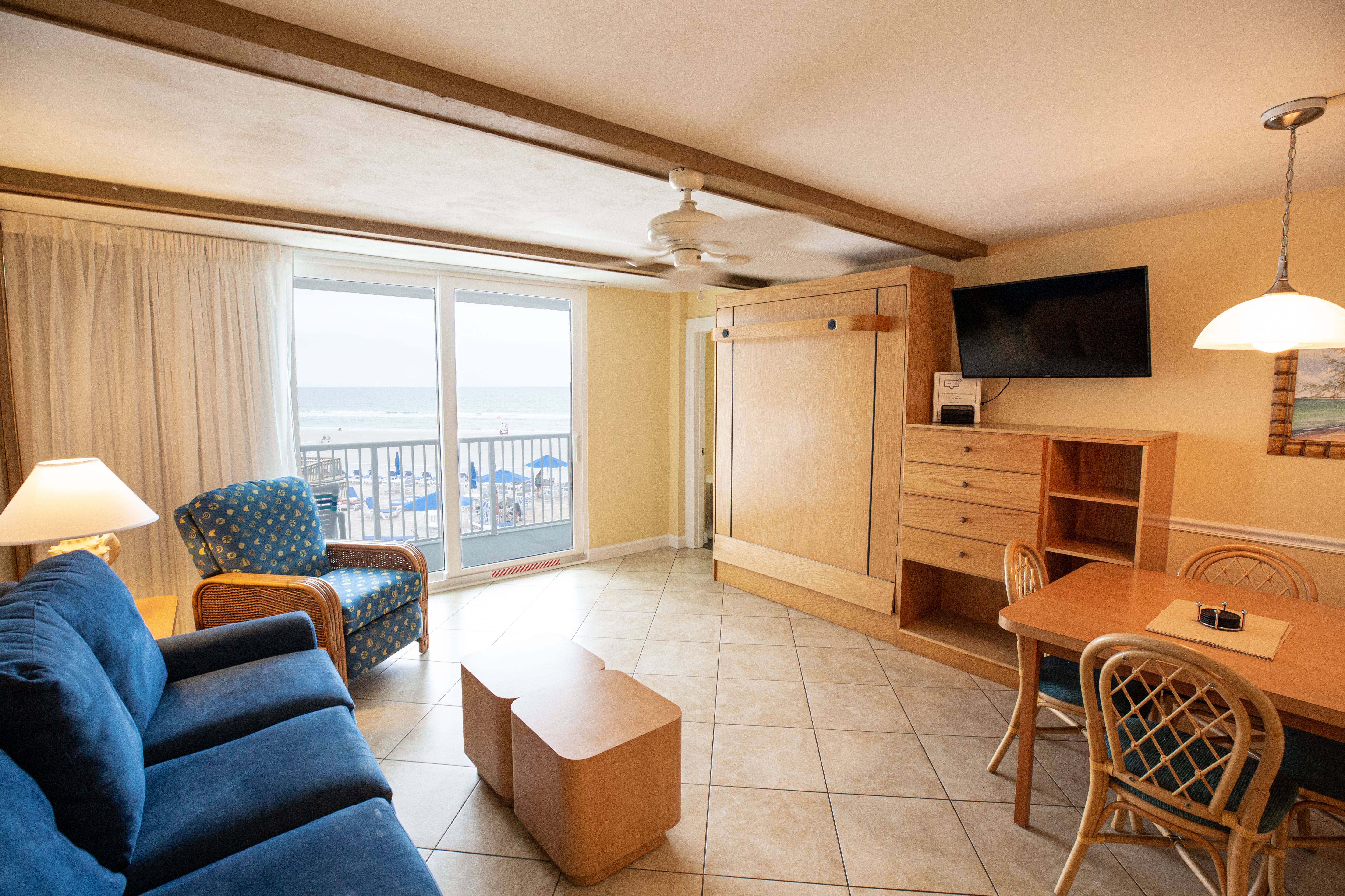 image The inviting living area showcases a blend of comfort and style with ocean views visible through the sliding glass doors.