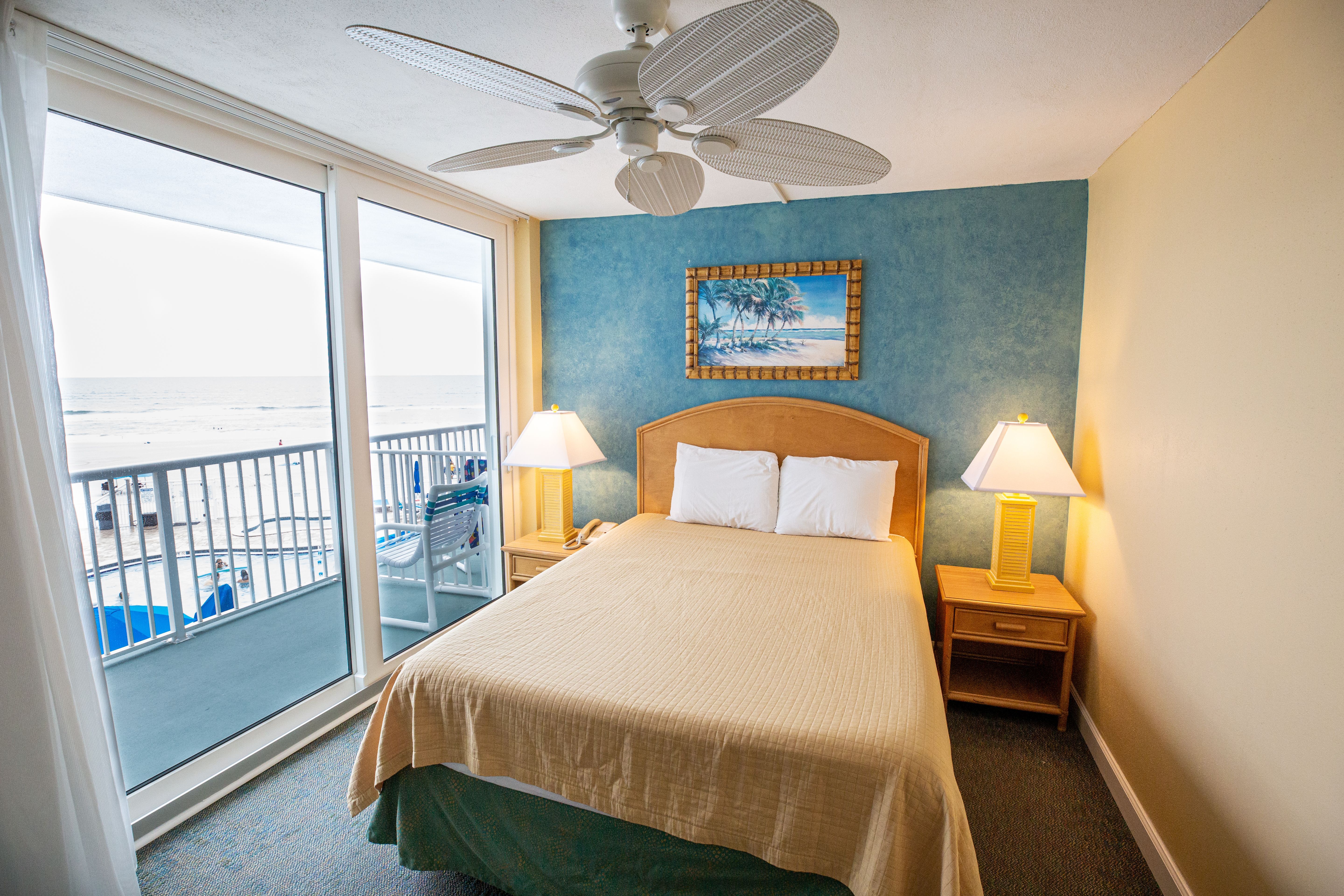image The cozy bedroom features a queen bed, and large windows that provide stunning views of the ocean and beach.