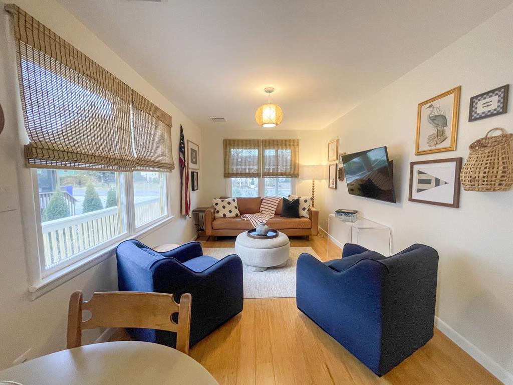 image Step inside to the inviting living space, where coastal decor and comfortable furnishings create a warm ambiance for relaxation after beach days.