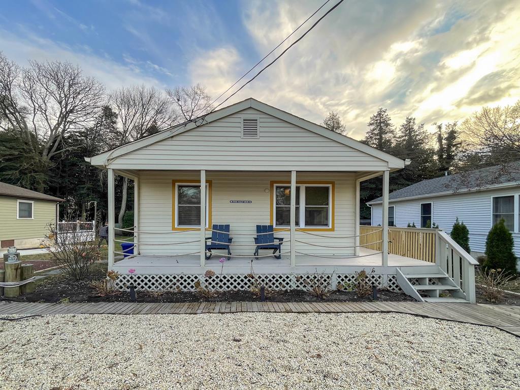 image Welcome to your coastal retreat at Cape May Beach, where the charming porch invites you to unwind with ocean breezes and peaceful views.