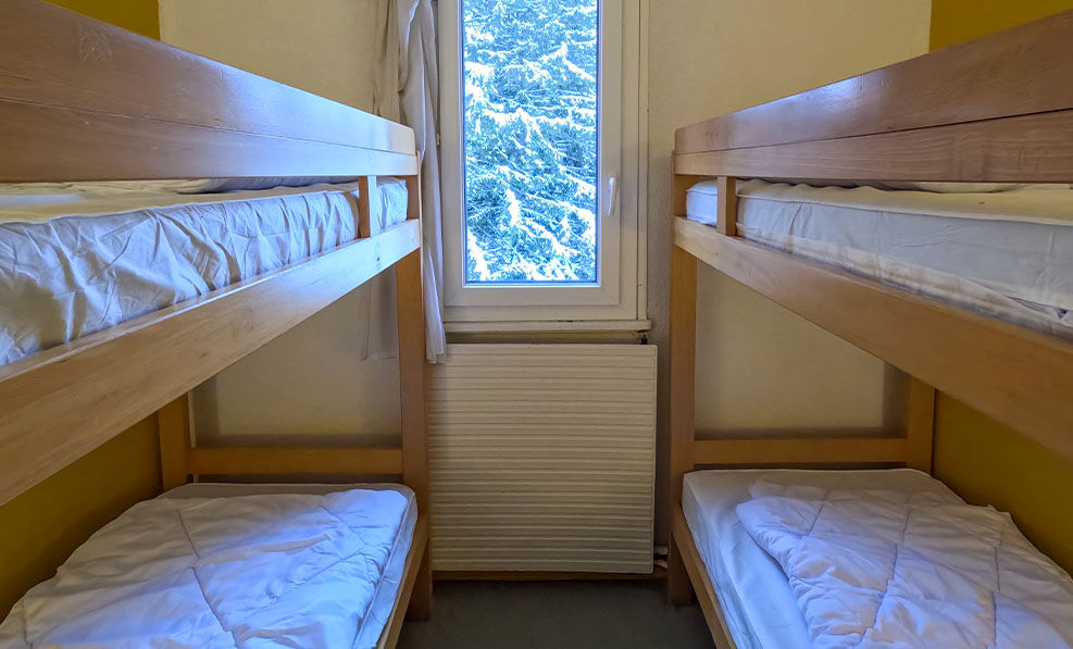 image The snug bedroom with bunk beds is ideal for families, providing a cozy corner for resting after outdoor adventures.