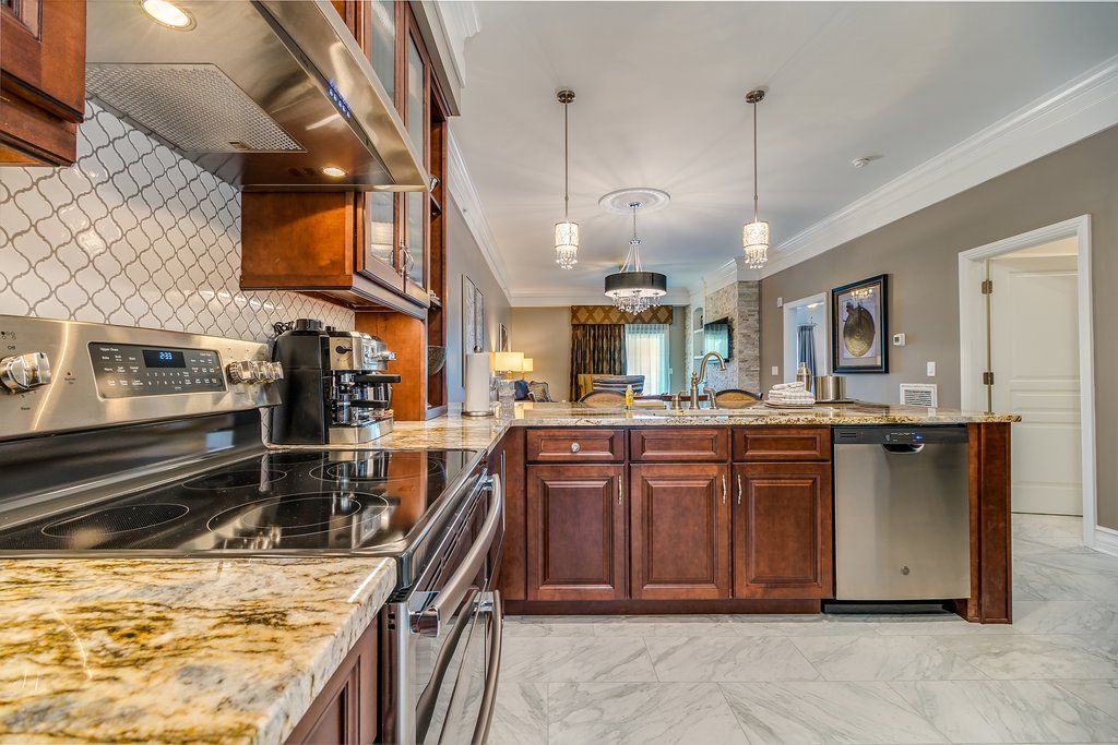 image This full kitchen features granite countertops and modern appliances, perfect for cooking and entertaining during your Williamsburg stay.