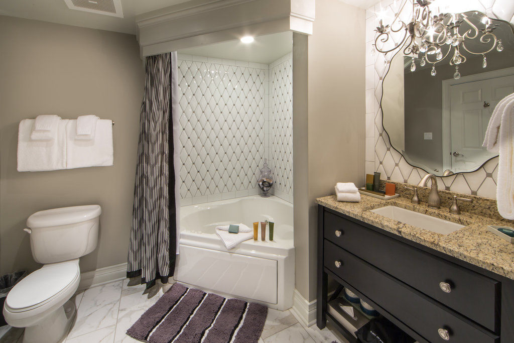 image A modern bathroom featuring elegant finishes, a spacious tub, and bright lighting for a refreshing experience