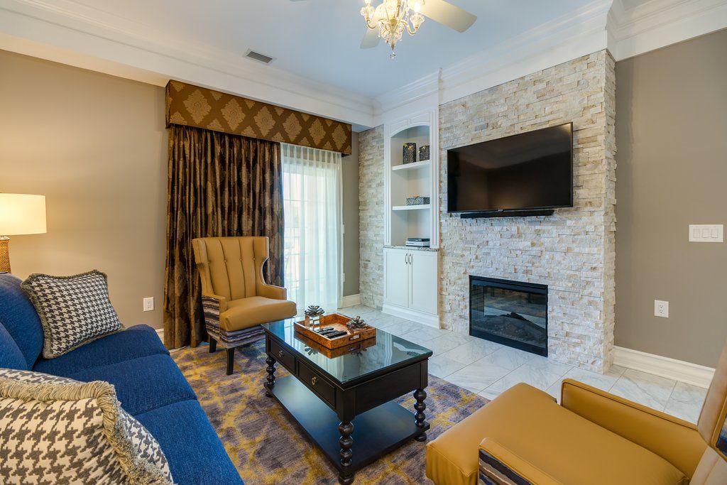 image The cozy living area, featuring a fireplace and ample seating, offers a stylish retreat for relaxation and family bonding.