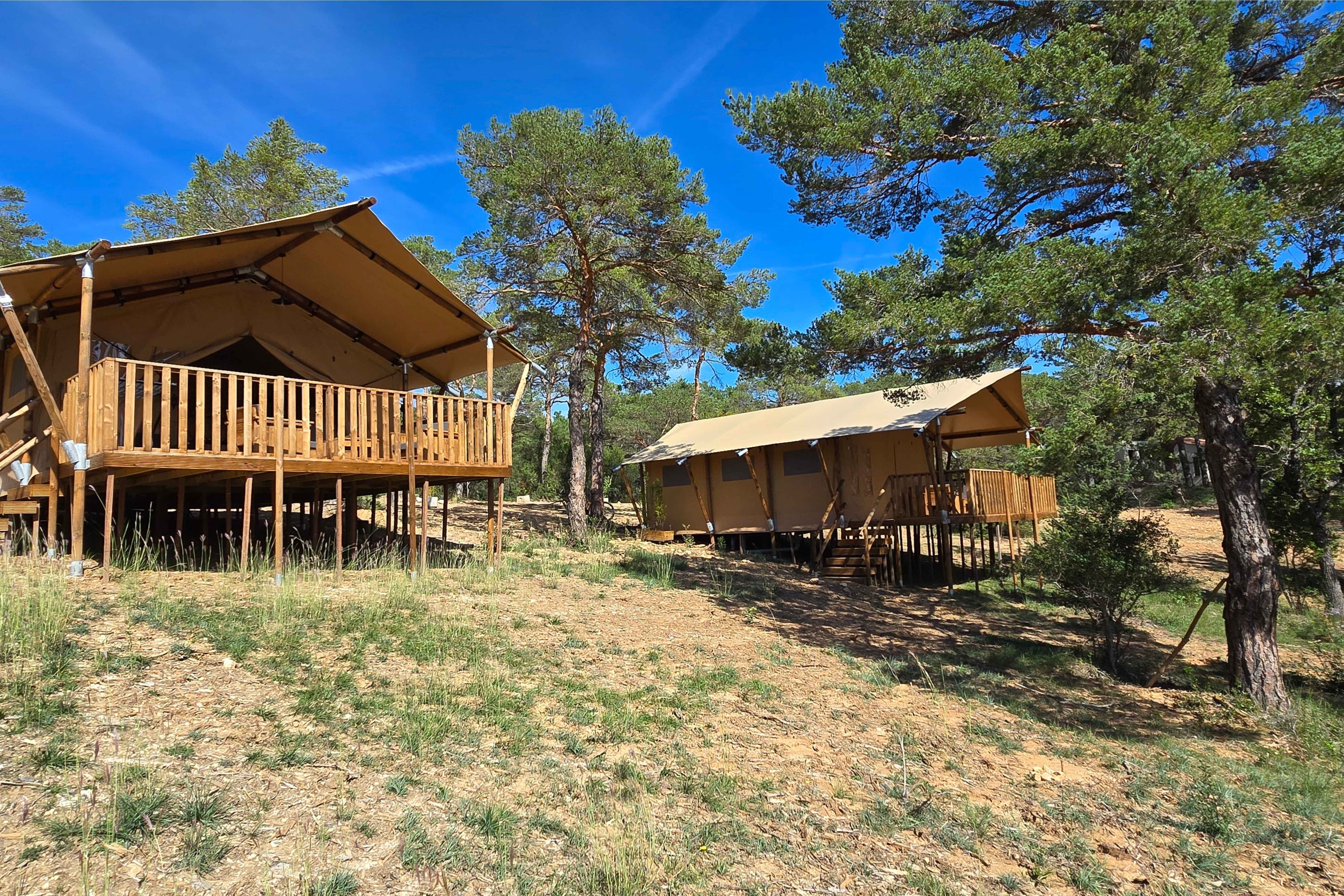 image The Tente Lodge at Camping Verdon features spacious, elevated eco-lodges nestled among trees, offering a harmonious blend with nature.
