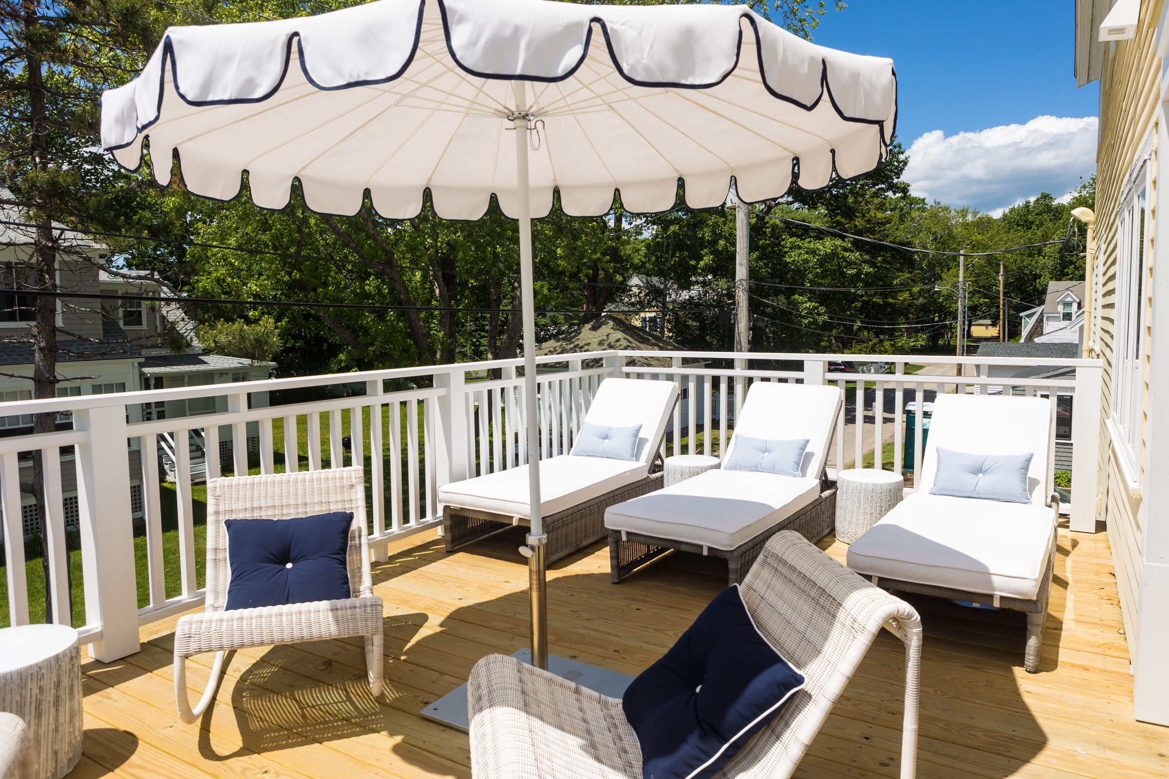 image Relax in style on the sunlit terrace, featuring lounge chairs and an umbrella for perfect afternoons soaking in the sun at Belair.