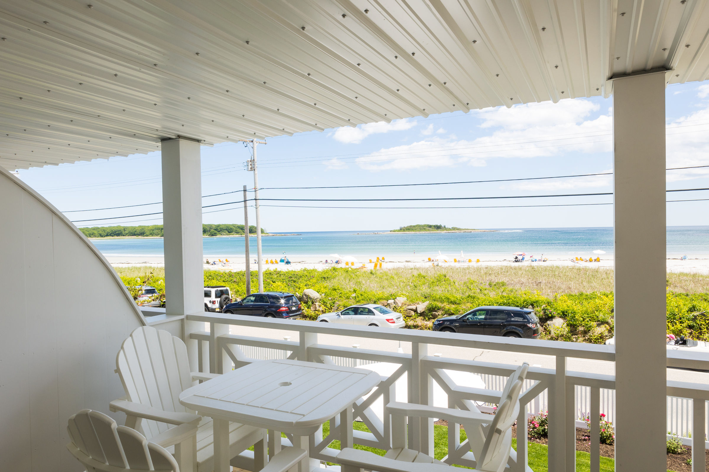 image Enjoy stunning beach views from the private balcony, complete with outdoor seating and direct access to the sandy shores of Goose Rocks Beach.