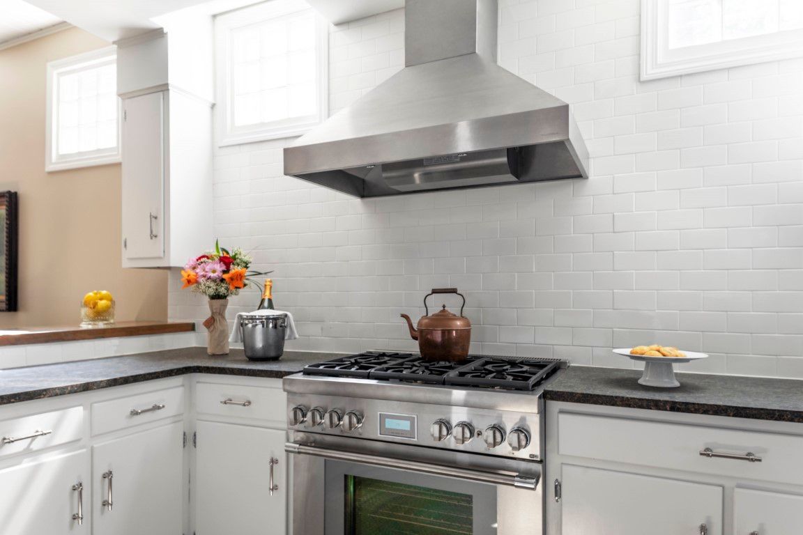 image This modern chef's kitchen showcases sleek stainless steel appliances and a bright, airy ambiance, ideal for culinary creations.