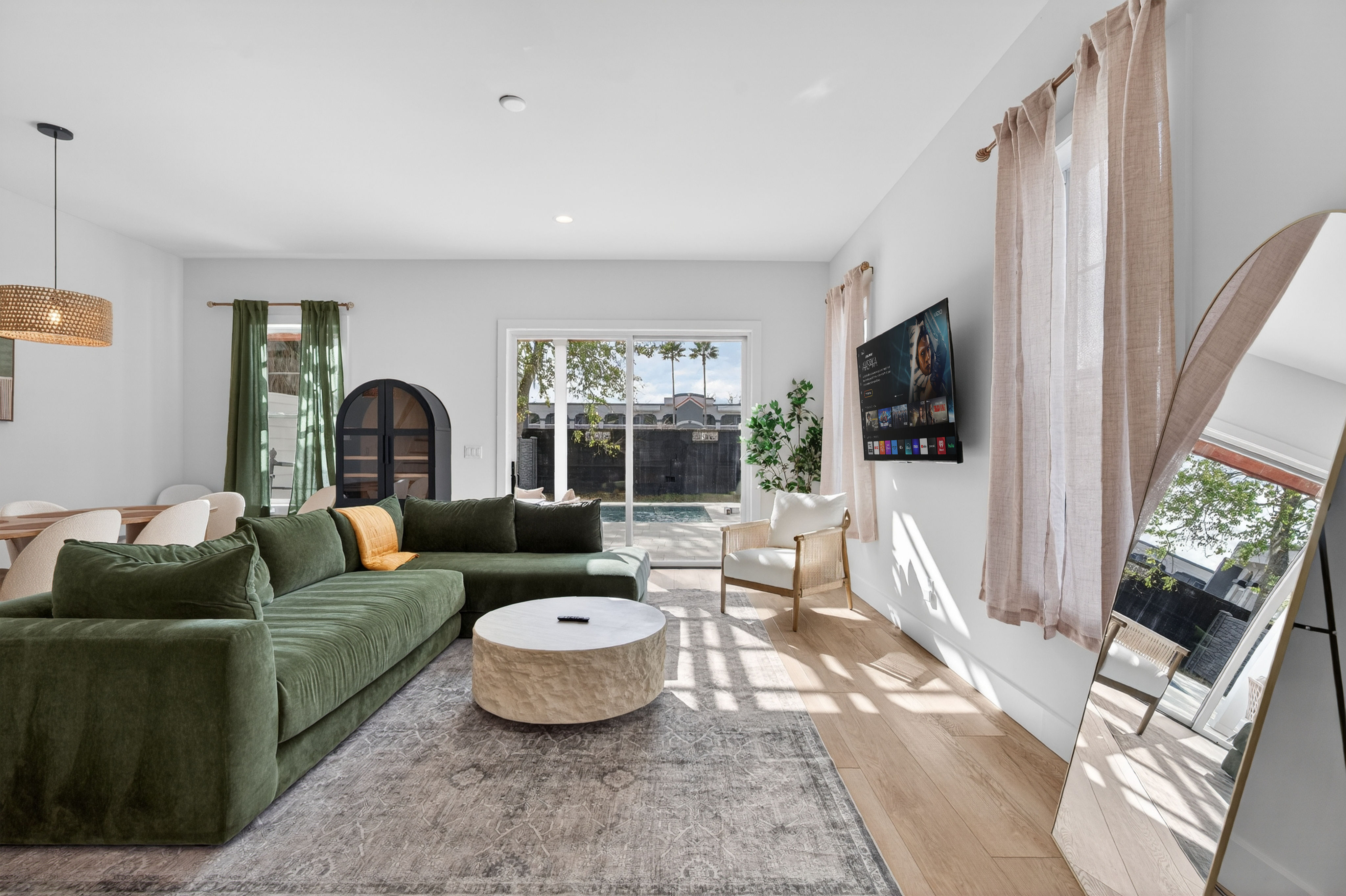 image A warm and airy space with a cozy seating area and sliding doors leading to the private pool outside.