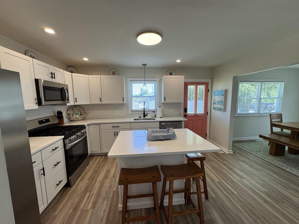 image Gather around the modern island in this sleek, stylish kitchen.