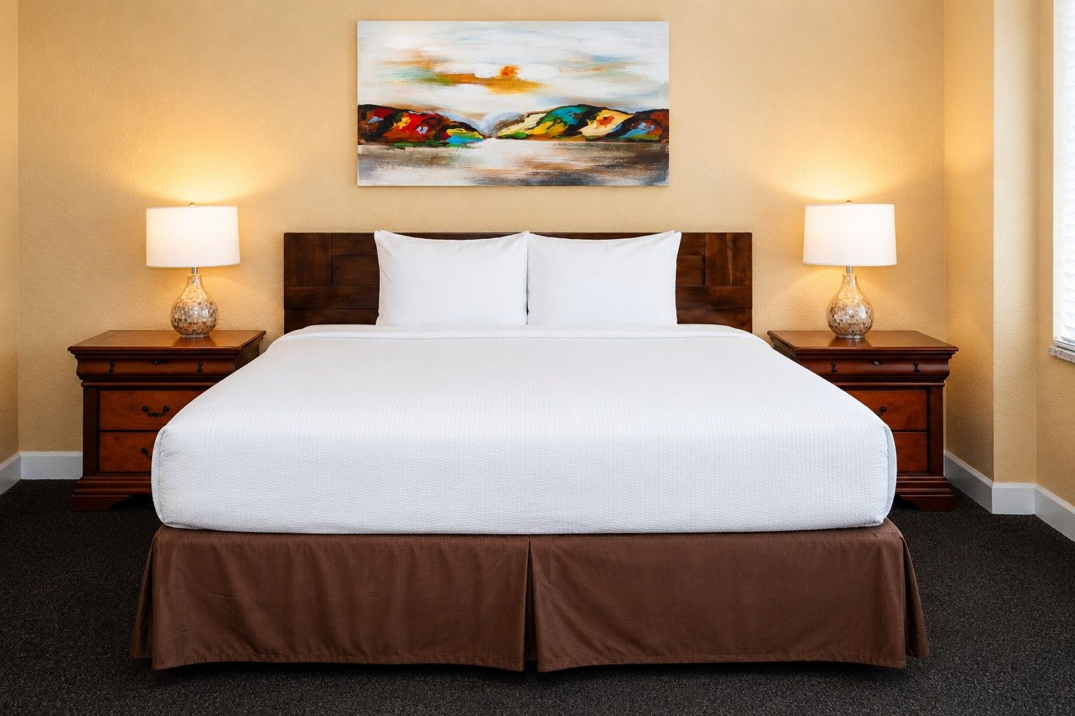 image A well-appointed bed scene with soft pillows and warm lighting, inviting you to unwind and relax.