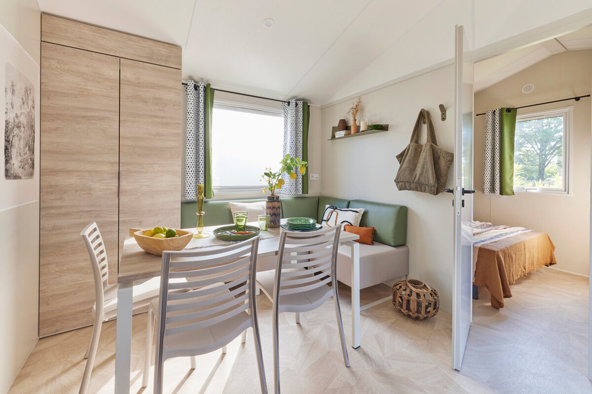 image The bright and inviting interior boasts a cozy dining area, nestled by large windows that let in abundant natural light.