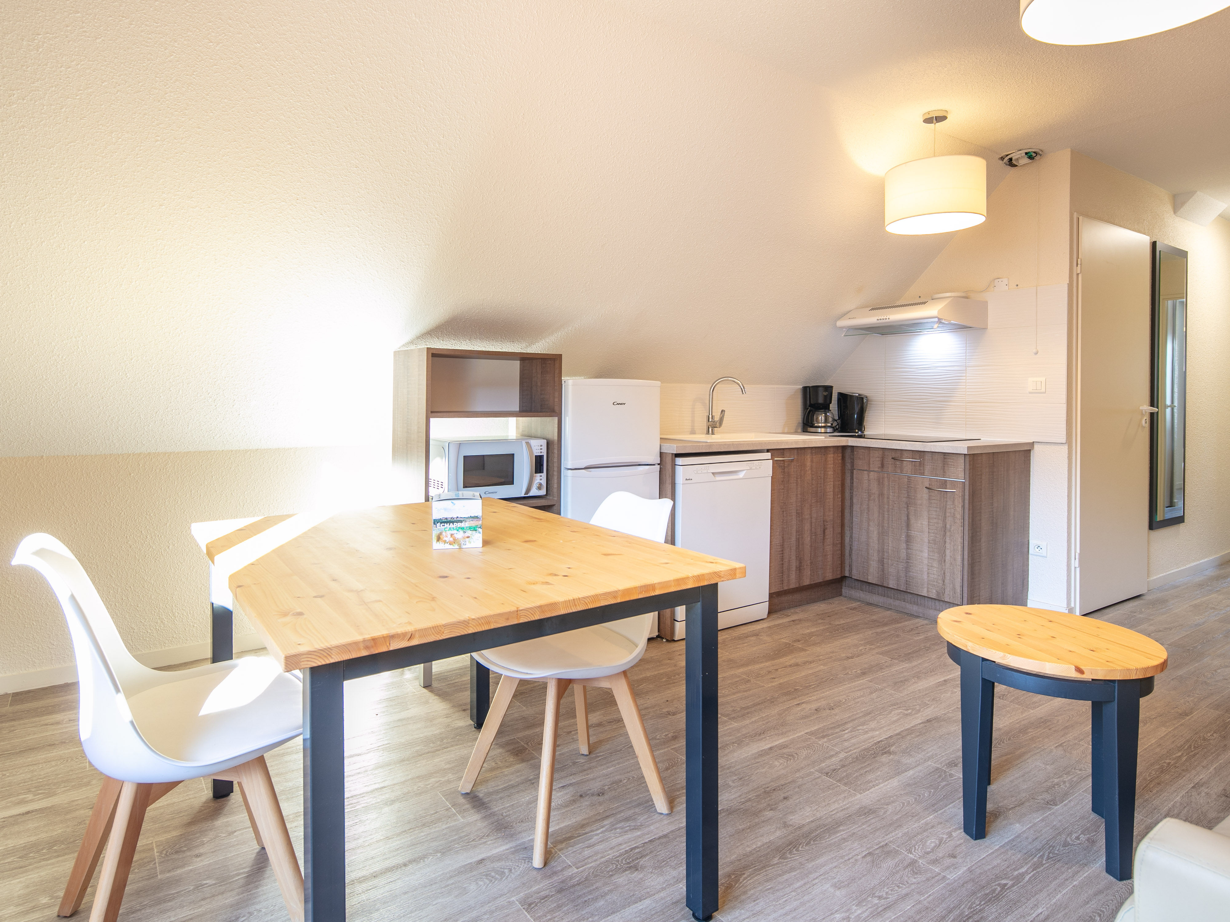 image The spacious dining area features modern furnishings, perfect for family meals after a day of adventure in the beautiful Alps.