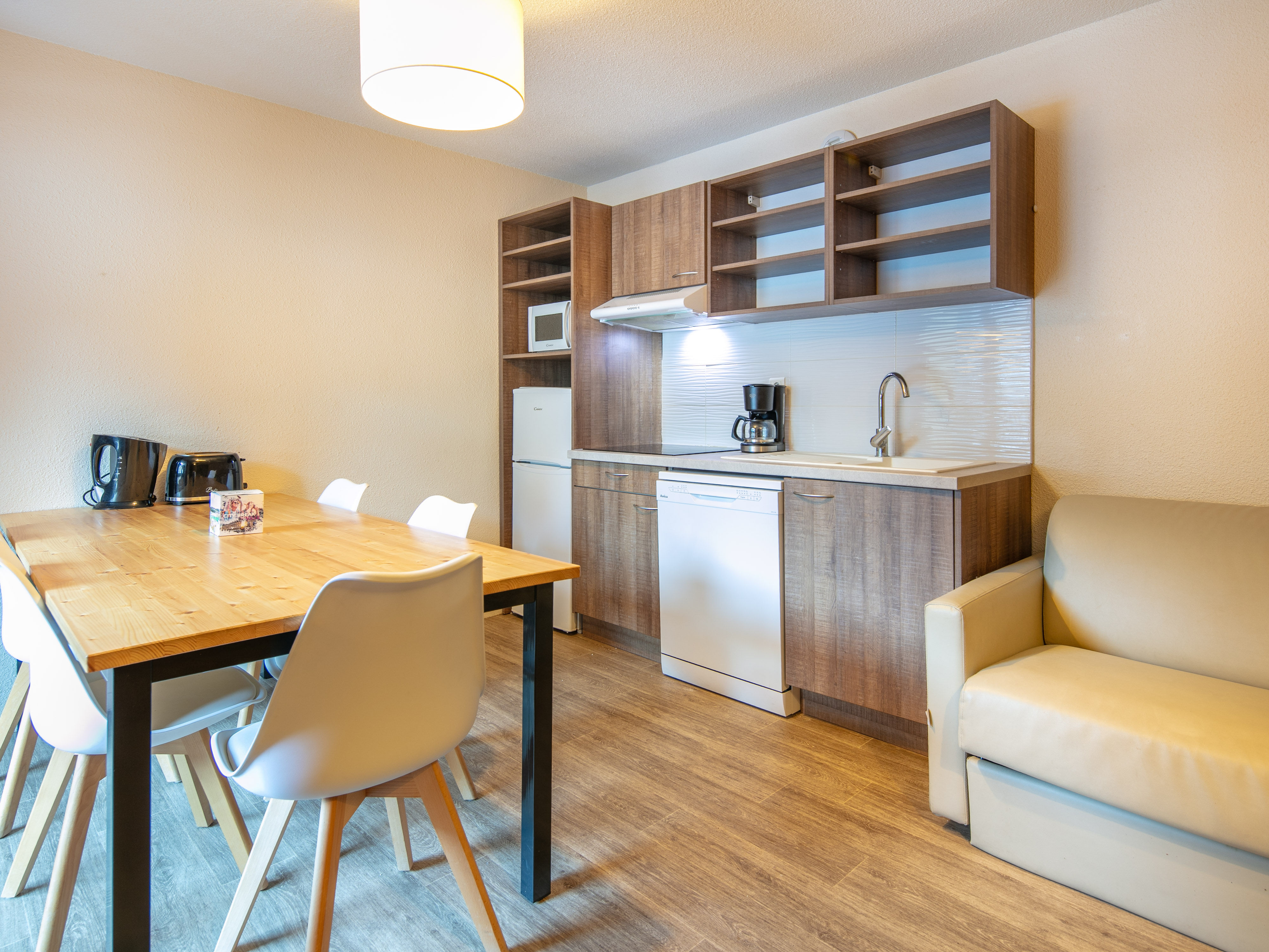 image The dining area harmonizes with the kitchen, offering an open and inviting atmosphere to enjoy meals together in a cozy alpine setting.