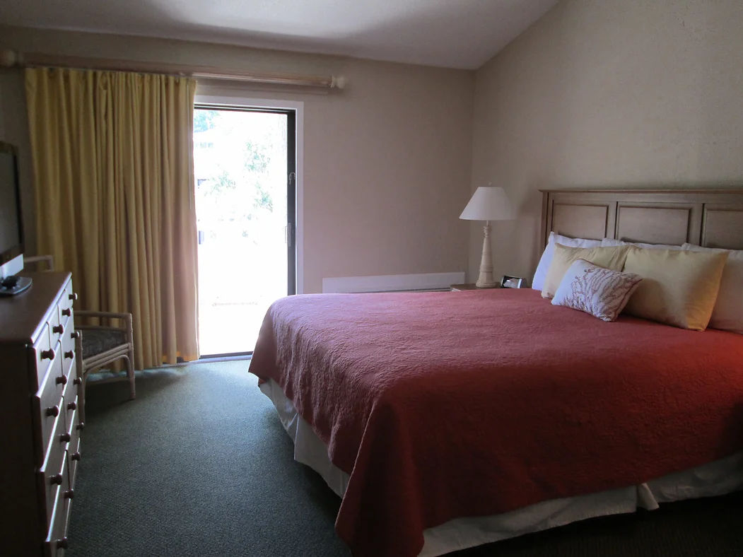 image Retreat to your cozy sanctuary with a view in this tranquil bedroom on Hilton Head Island.