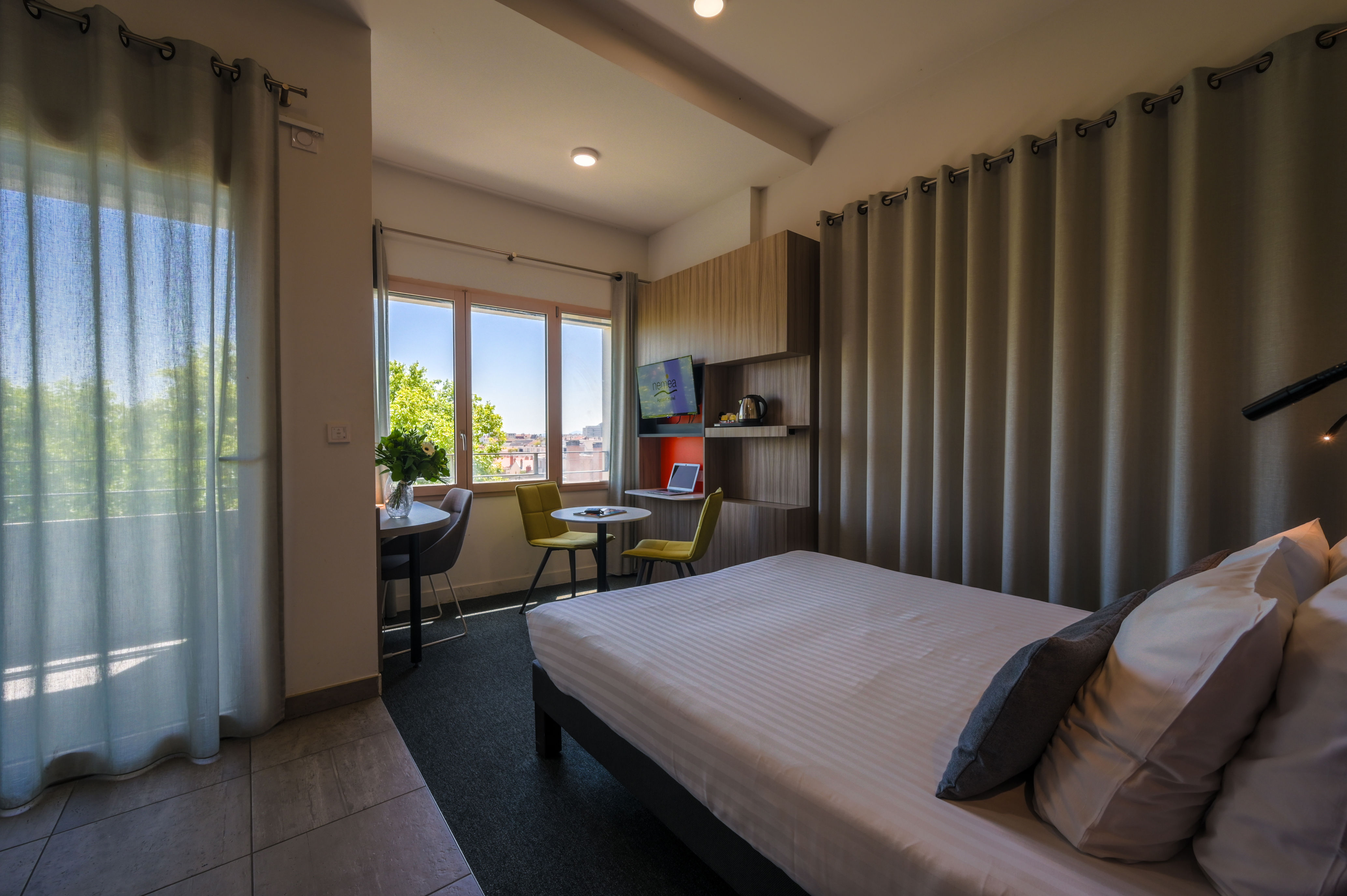 image Comfortable double bed with access to a private balcony, offering a pleasant setting in the heart of Lyon.