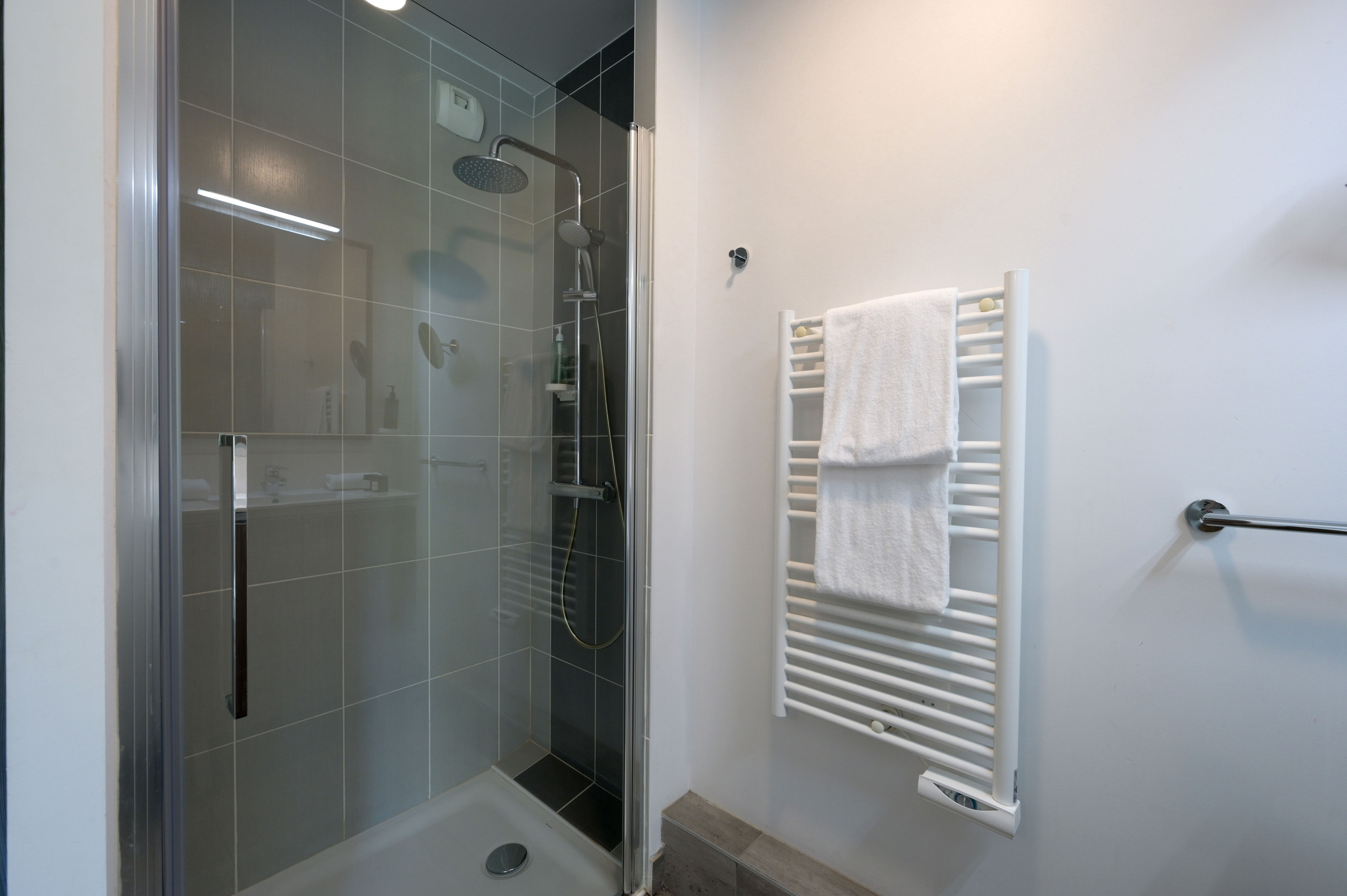image Modern bathroom with walk-in shower and sleek fittings for everyday comfort.