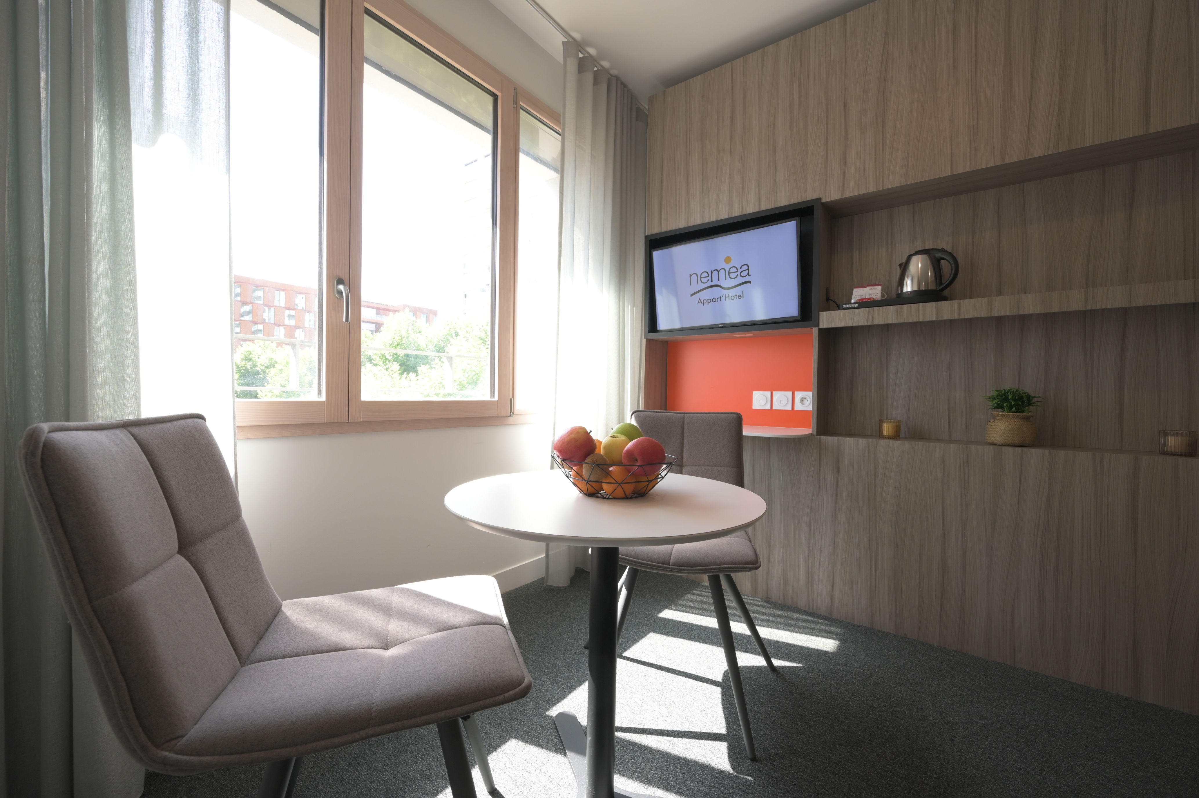 image Dining and seating area by the window offering a pleasant space to relax.