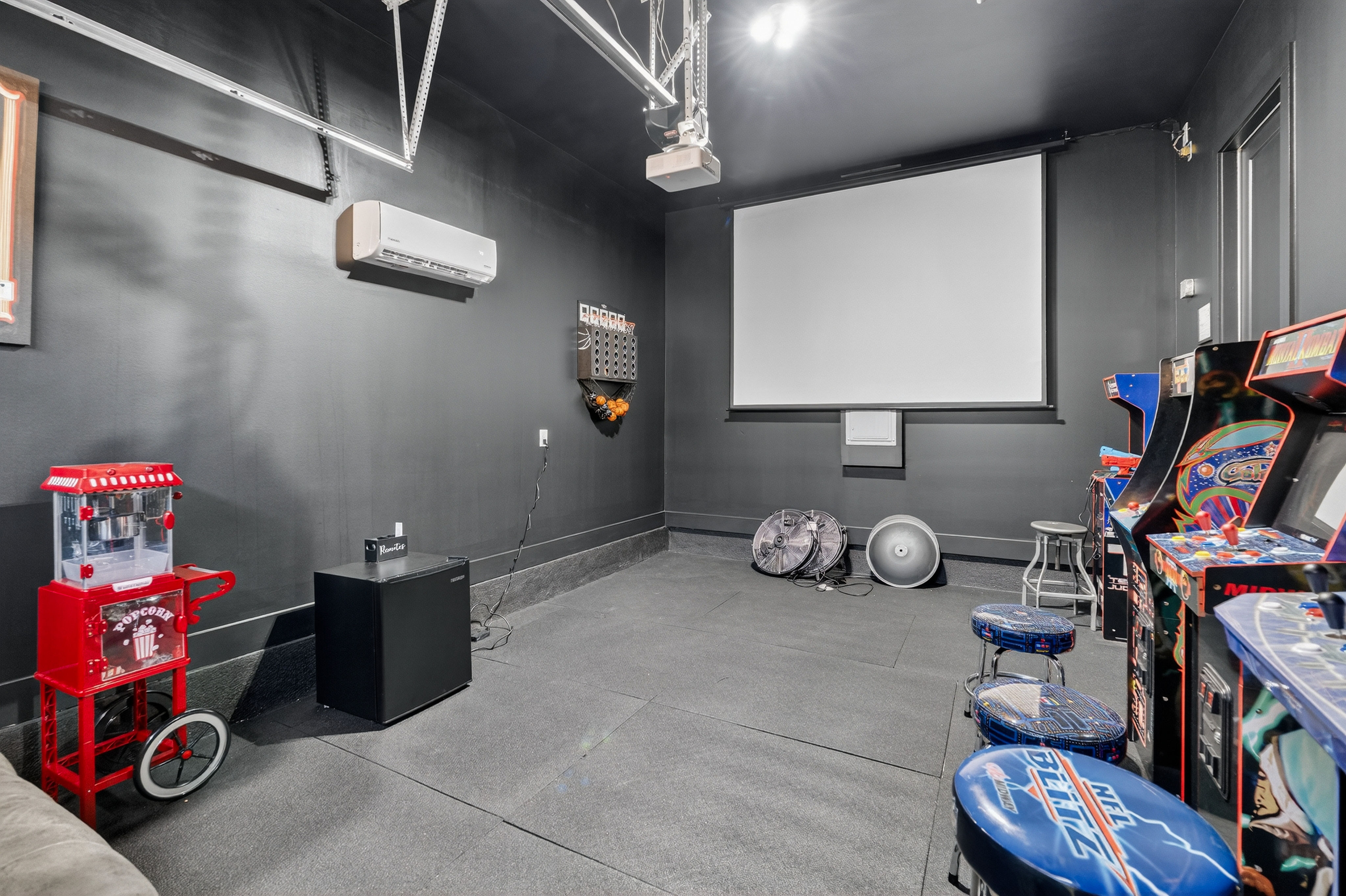 image Bring the fun home in the vibrant arcade and projector room — perfect for game nights and movie marathons.