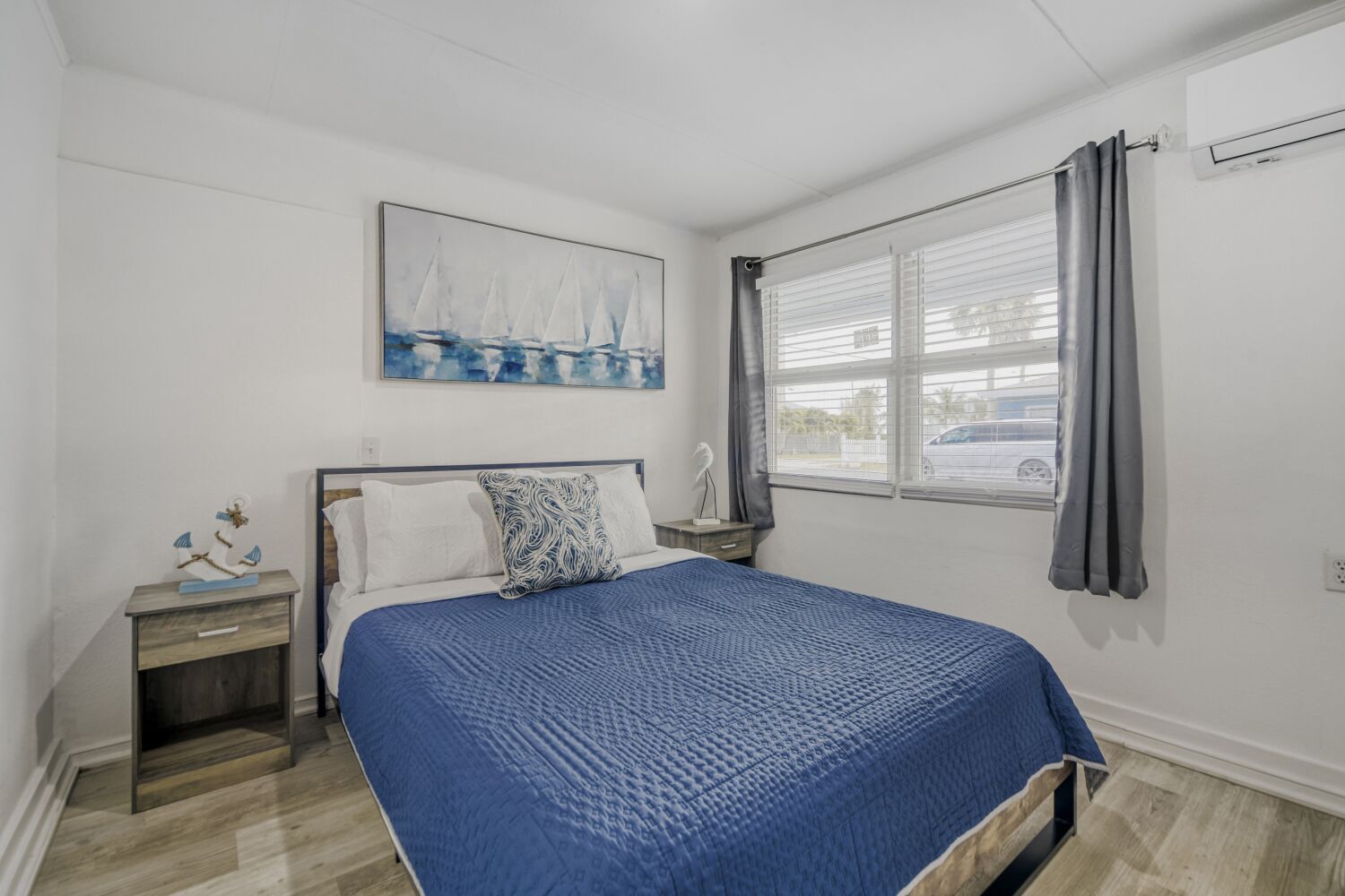 image Inviting bedroom includes a plush bed with fresh linens, bedside reading lamp, blackout curtains, and calming decor for restful sleep.