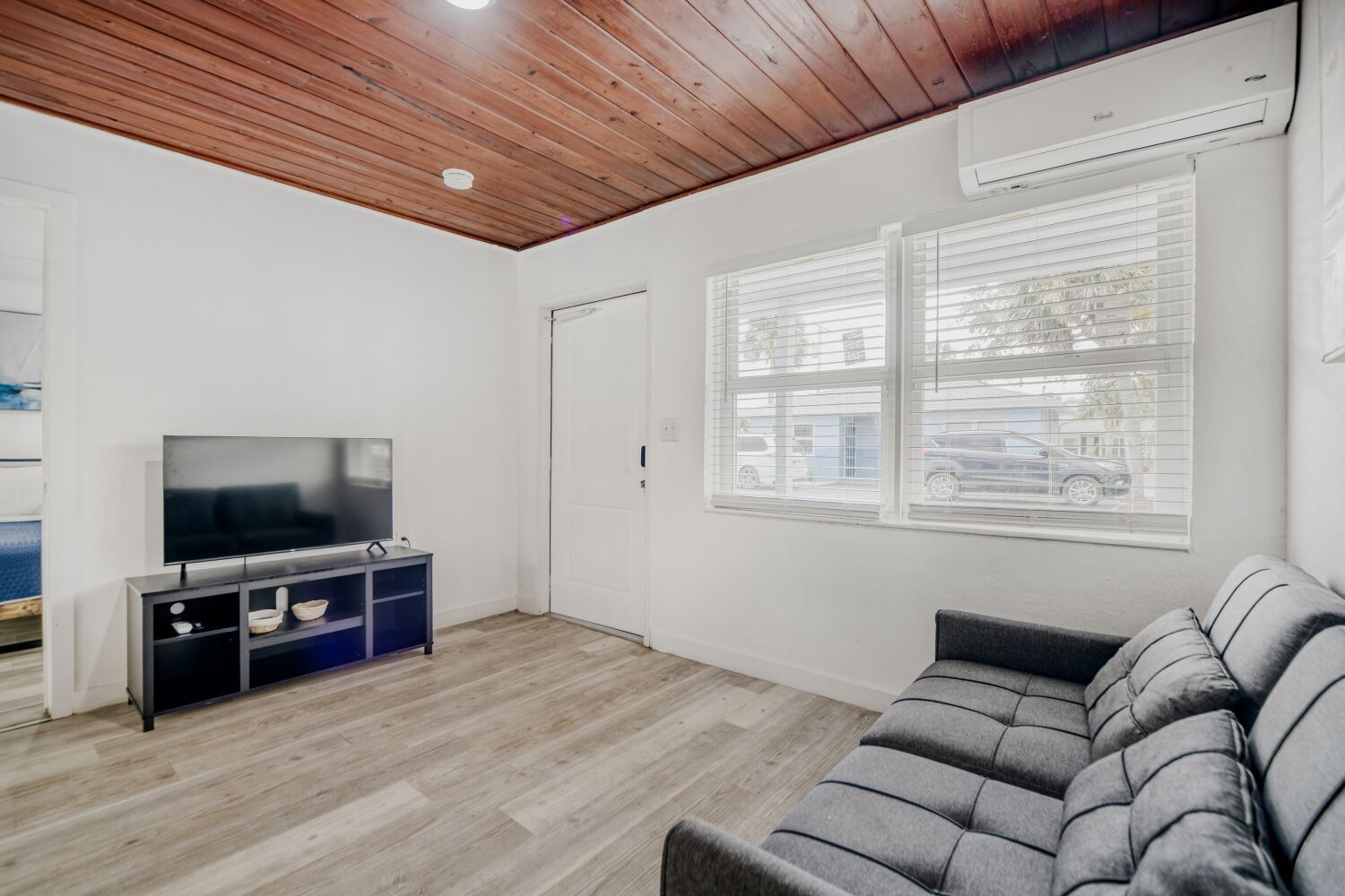 image Bright lounge features a reclining sofa, flat-screen TV, and split AC for movie nights in total comfort.