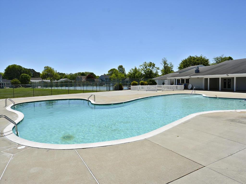 image Dive into relaxation at the community pool (accessible for a fee), surrounded by serene greenery and offering a perfect retreat for family fun and leisure.