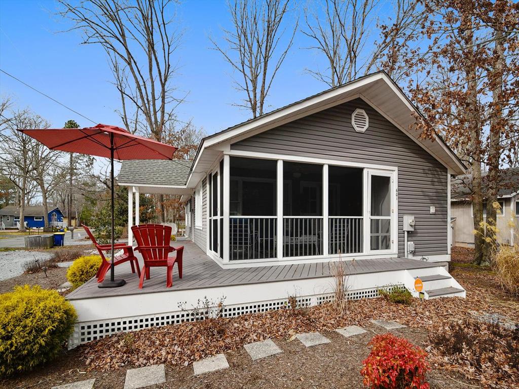 image This bright and airy property showcases a cozy screened porch, ideal for relaxing with a book while enjoying the picturesque views of the surrounding nature.
