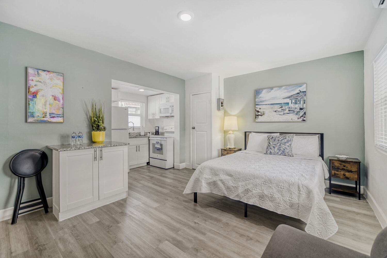 image Inviting studio retreat with a plush bed, cozy seating nook, ample storage, and modern art for a peaceful atmosphere.