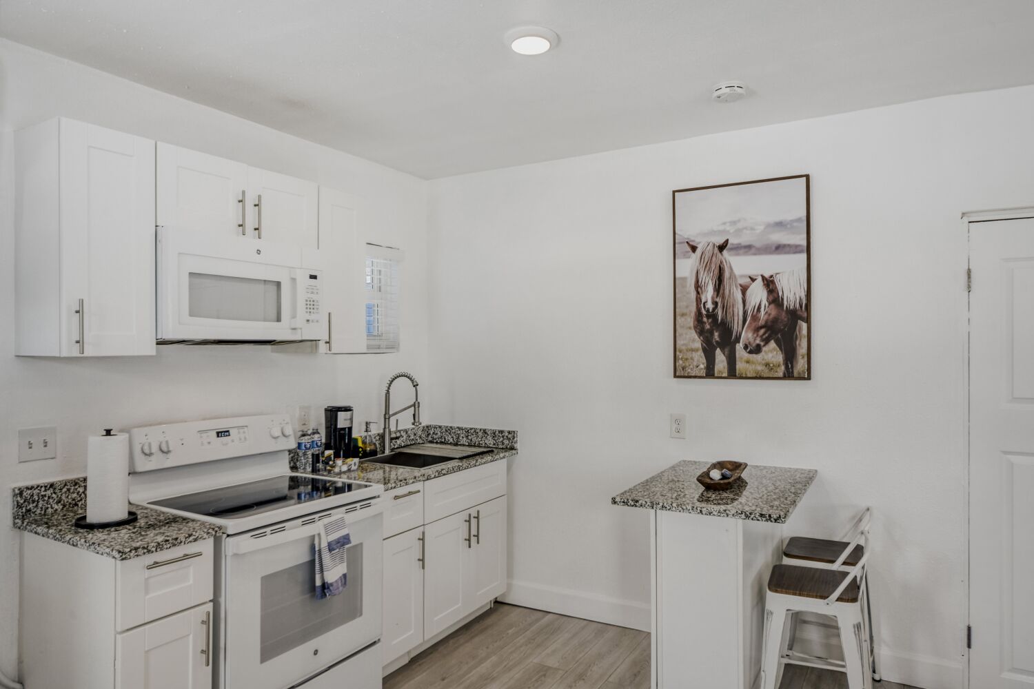 image Fully equipped kitchen features granite countertops, full-size appliances, microwave, coffee maker, and all the essentials for homemade meals.