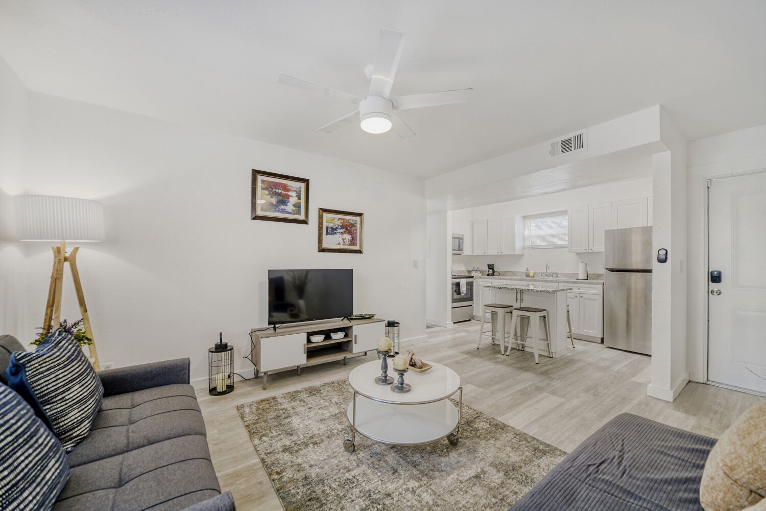 image Stylish living room features a comfy sofa, flat-screen TV, and thoughtfully curated décor, creating a welcoming space to unwind.