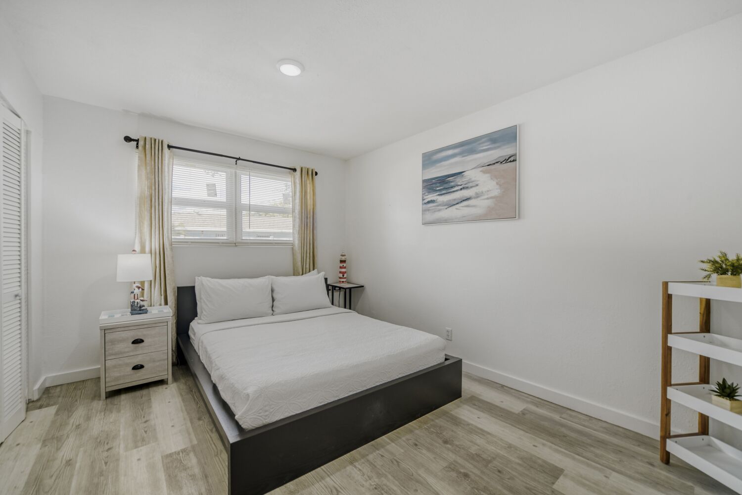 image Peaceful bedroom includes a plush bed with soft linens, nightstand with lamp, and blackout curtains for a restful night’s sleep.