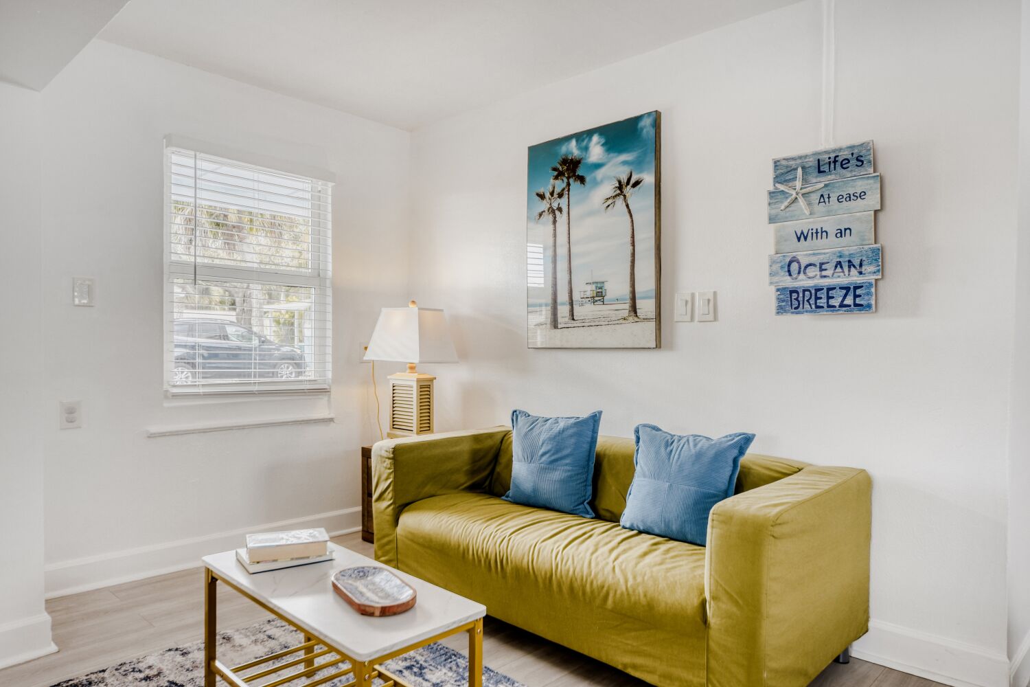 image Sunlit living room features a vibrant sofa, curated coastal art for cozy evenings in.