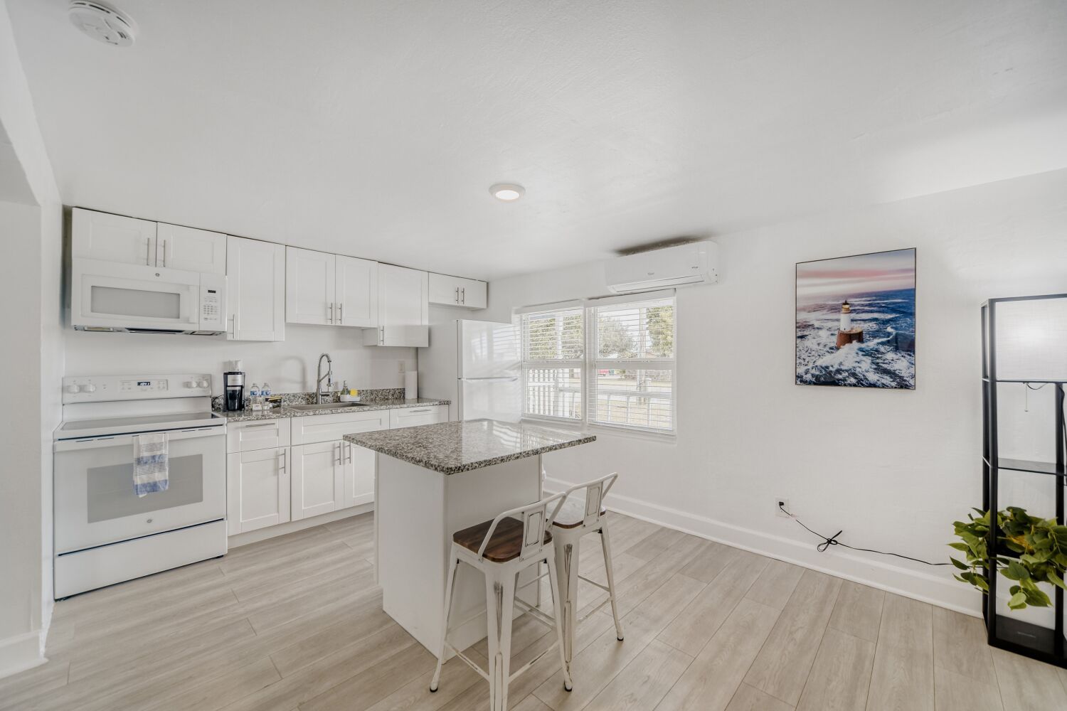 image Modern kitchen equipped with full-size appliances, spacious quartz countertops, and all essentials for effortless home-cooked meals.