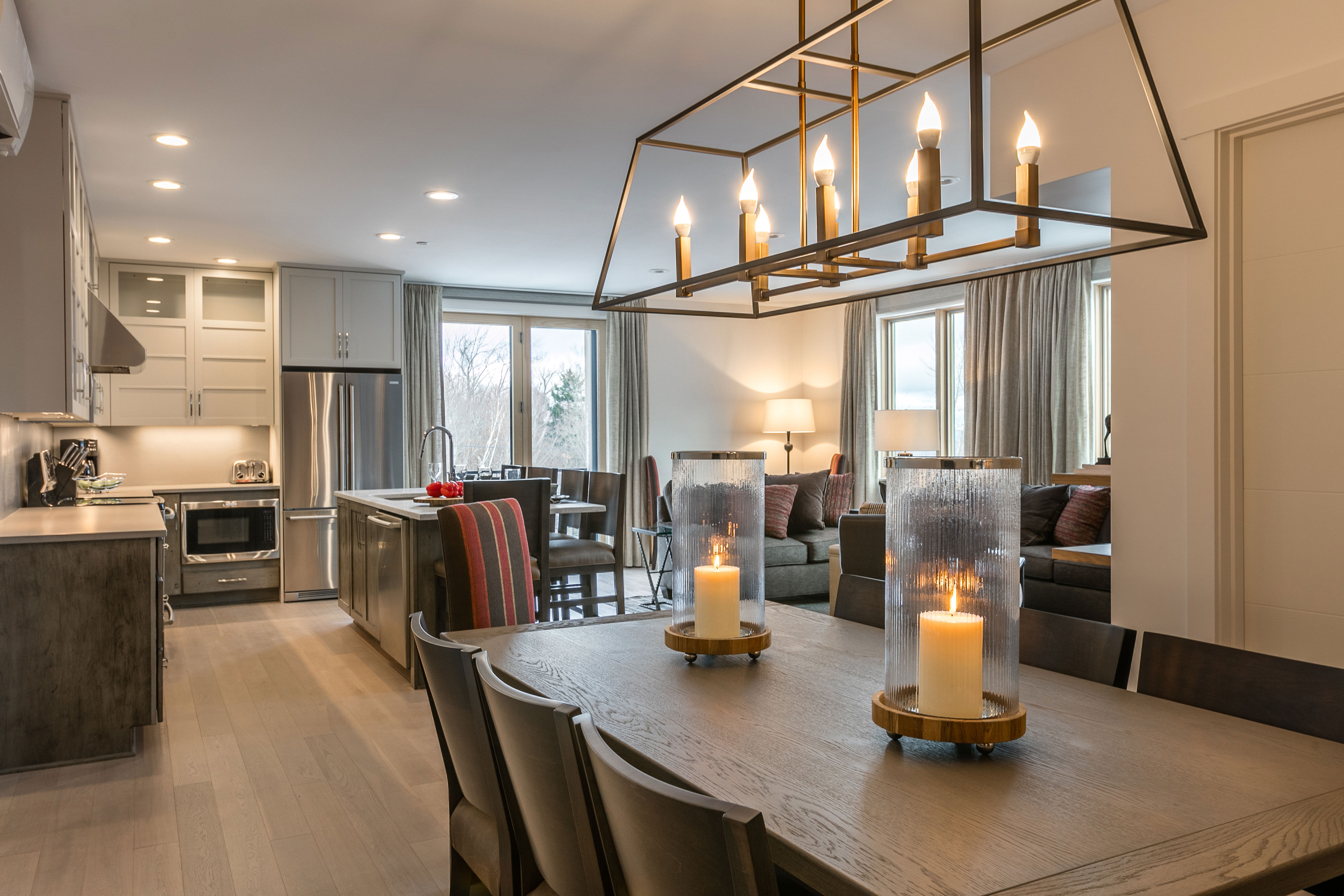 image The open-concept living and dining area is filled with natural light, providing a welcoming space to relax, dine, and spend time together.