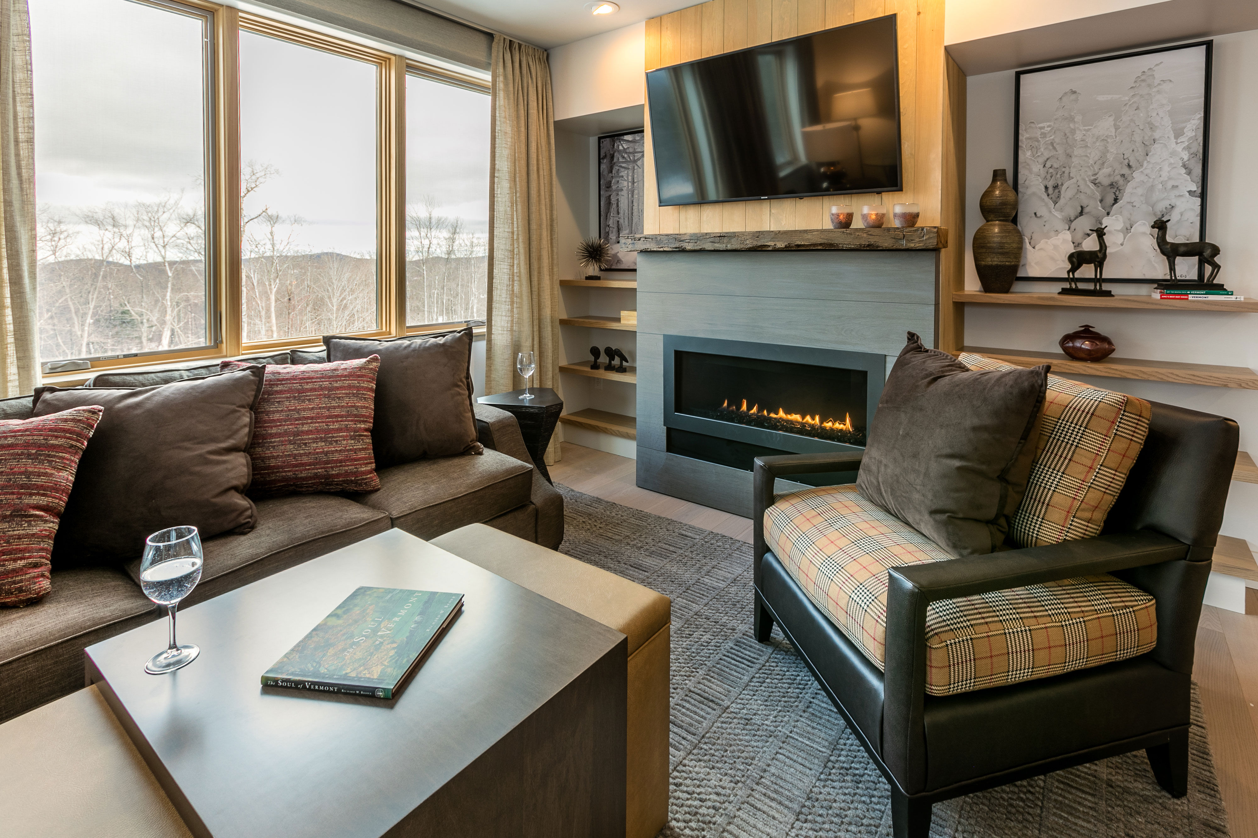 image This bright living room features large windows and tasteful décor, offering a comfortable place to unwind after a full day on Okemo Mountain.