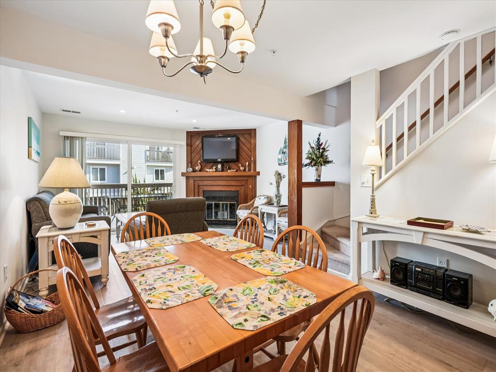 image Spacious dining area flowing into a cozy living room creates a welcoming spot for family meals and game nights after the beach.