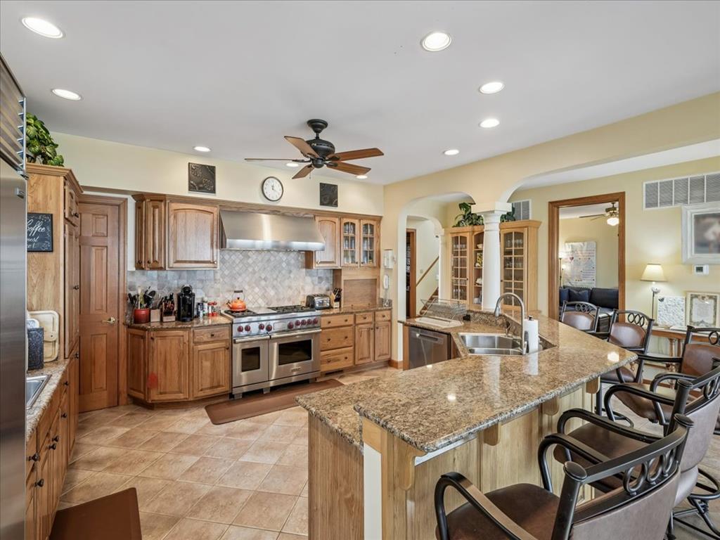 image The open-concept kitchen is designed for entertaining, with ample seating and a stylish layout that blends functionality and aesthetics.