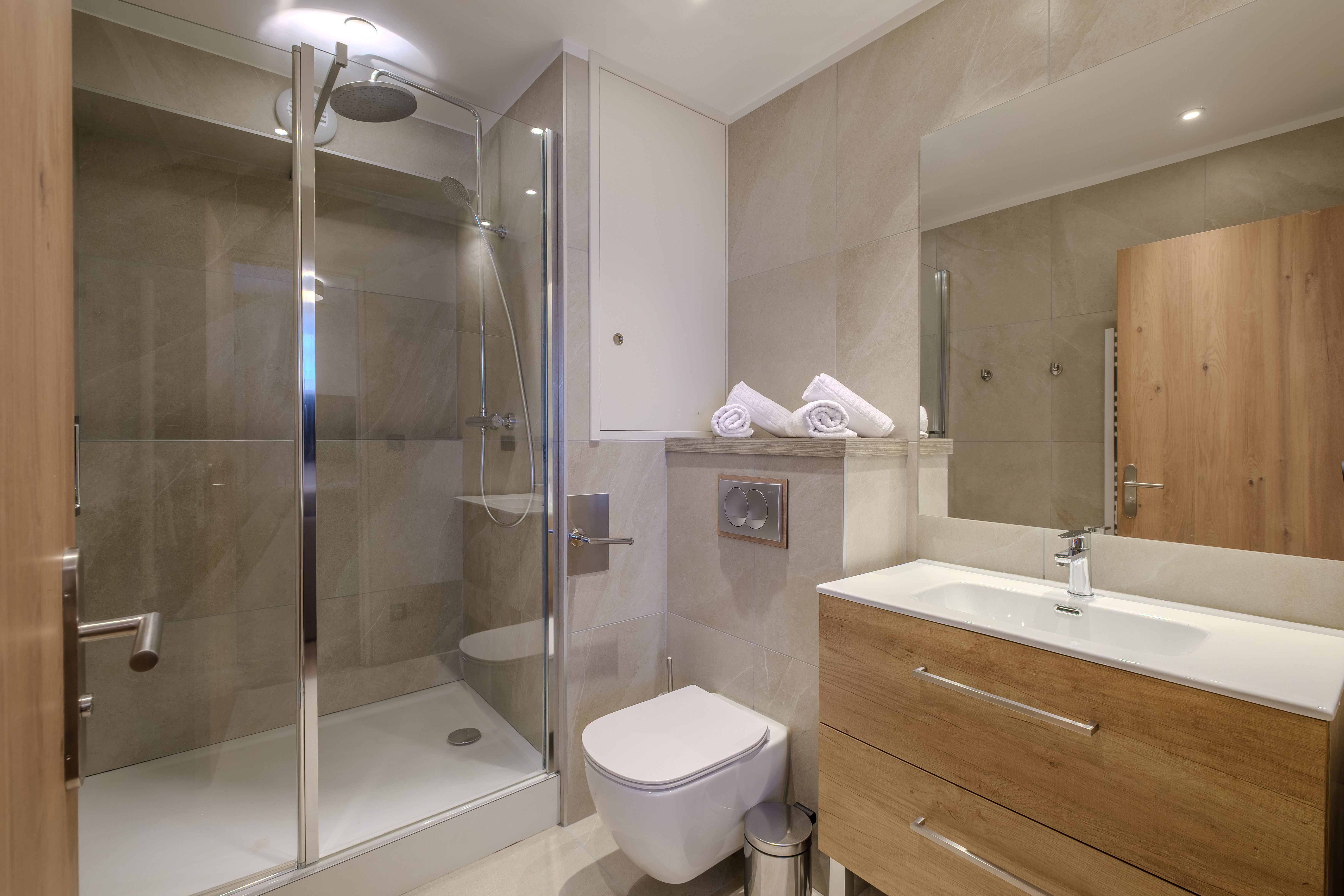 image The modern bathroom features a sleek shower and contemporary finishes for everyday comfort.