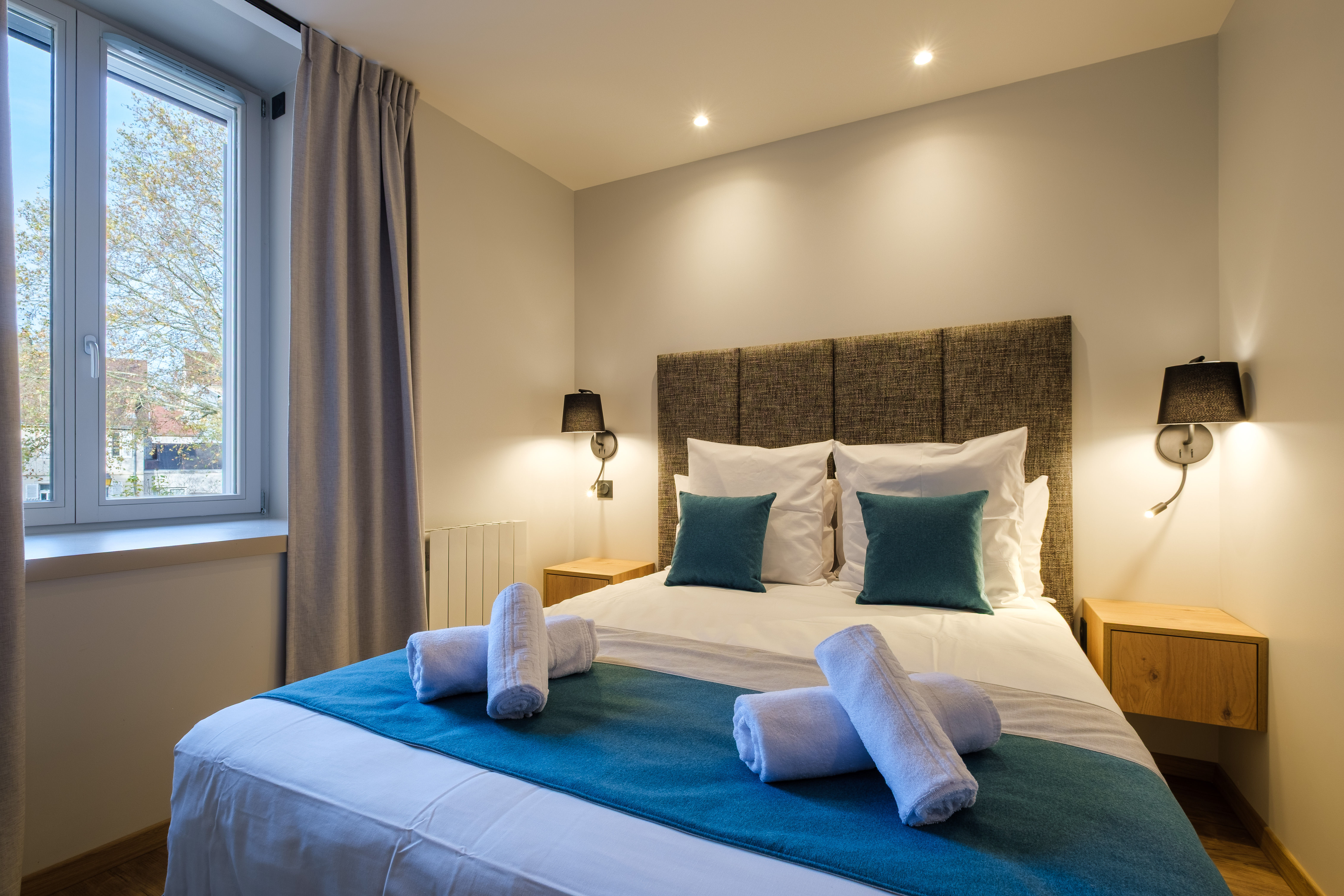 image The cosy double bedroom is thoughtfully decorated with comfortable bedding and soft lighting for a restful night’s sleep.