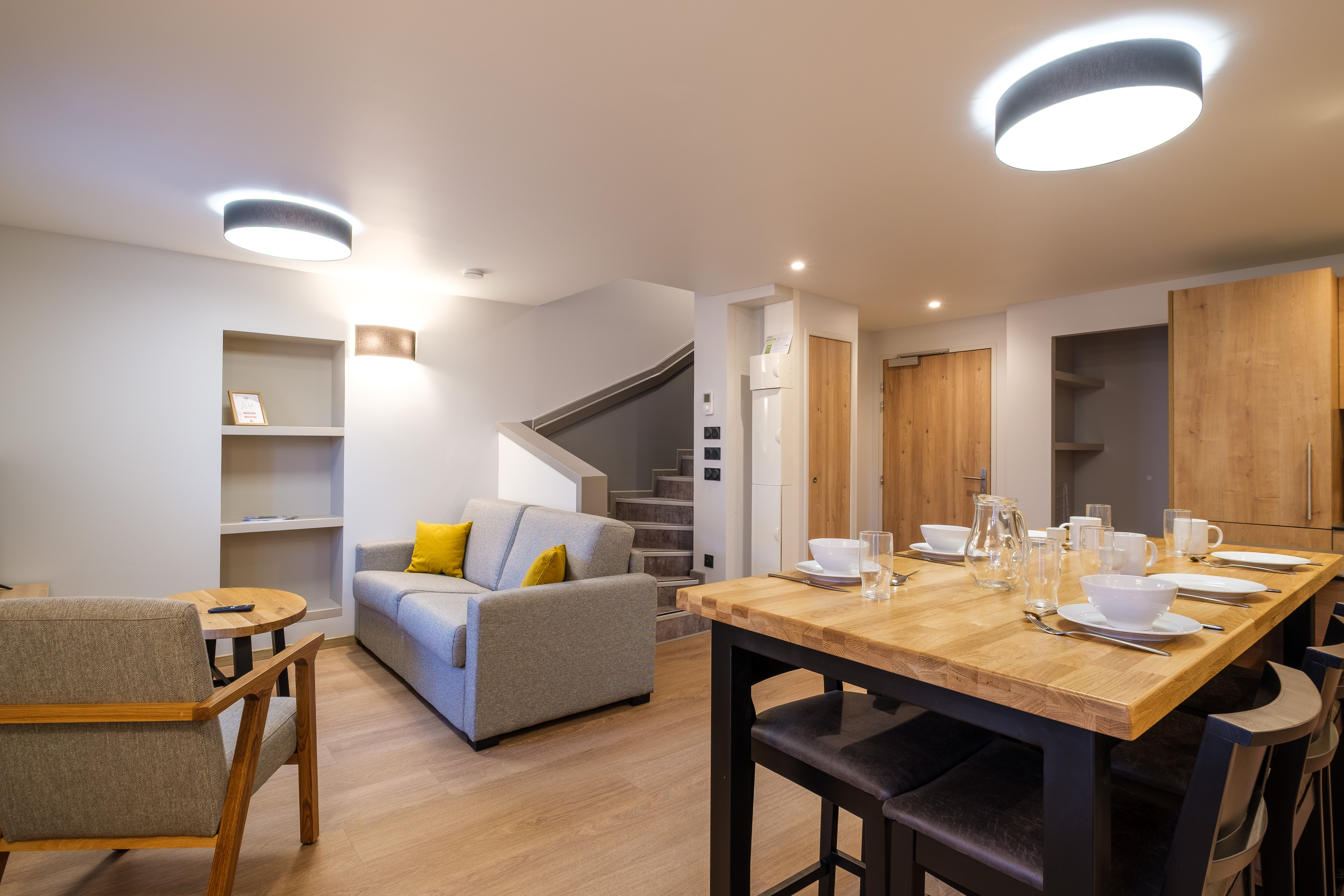 image The inviting living area features comfortable seating and a dining table, creating a welcoming space for relaxing and shared meals.